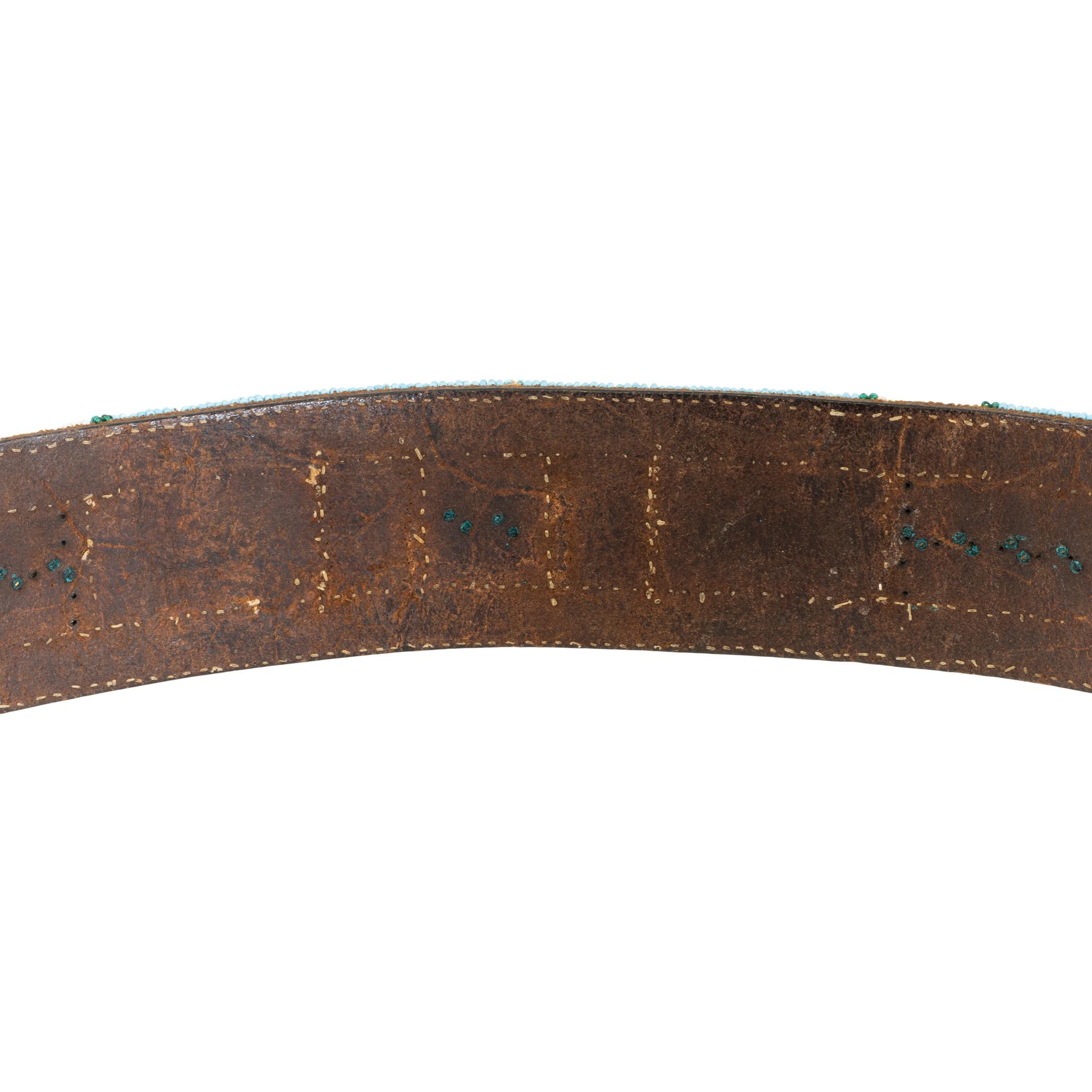 Nez Perce beaded belt on harness leather adorned with brass diamonds in the center. Trunk piece - stored and in great condition. Beautiful colors of blues, reds, whites, orange and green. No disappointments here!! Ex. Likkel.

Period: First quarter