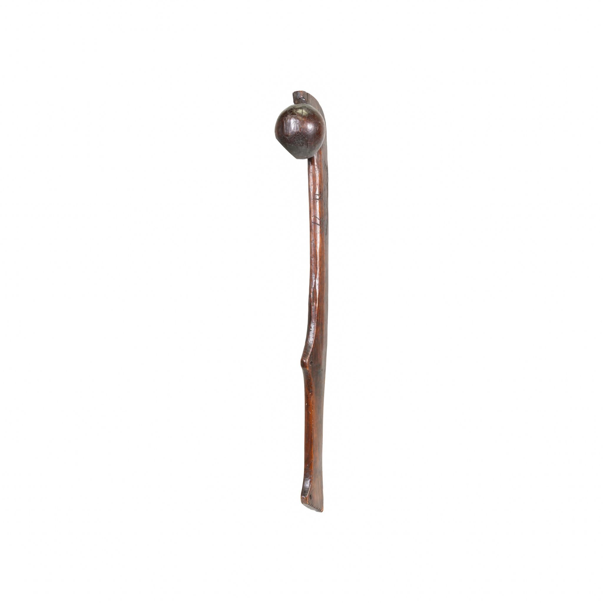 Native American horse pictorial ball headed club with stylized carved running Indian pony on left side next to ball. Two holes cut for drops, exceptional patina with much wear to hand grip from use. Small square shank nails on shaft to round head.