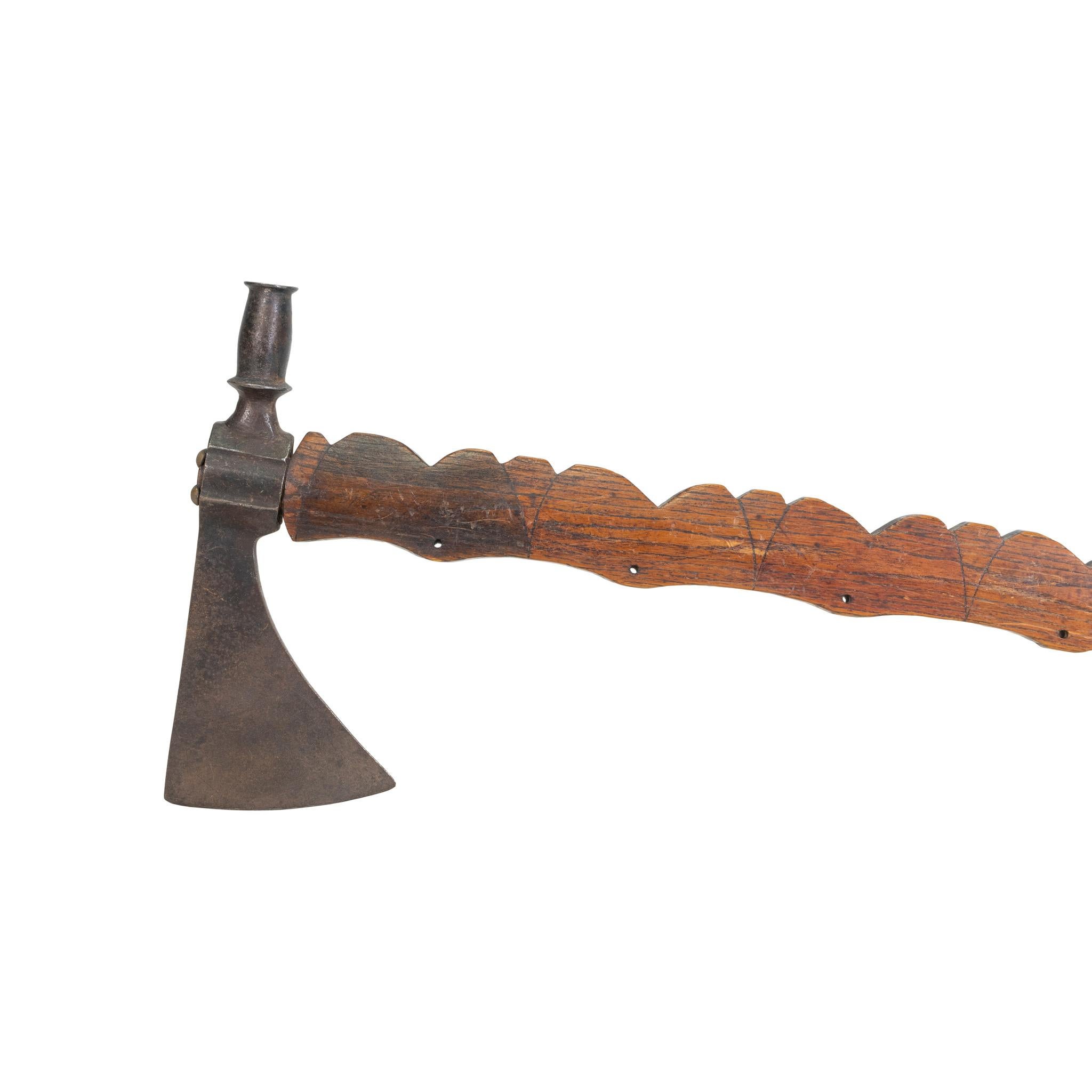 Native American pipe tomahawk with incised and file burnt handle. Eight holes for drops, scalloped haft. This piece used for smoking rather than fighting. This piece was kept for several generations in a private north woods museum in Minocqua,