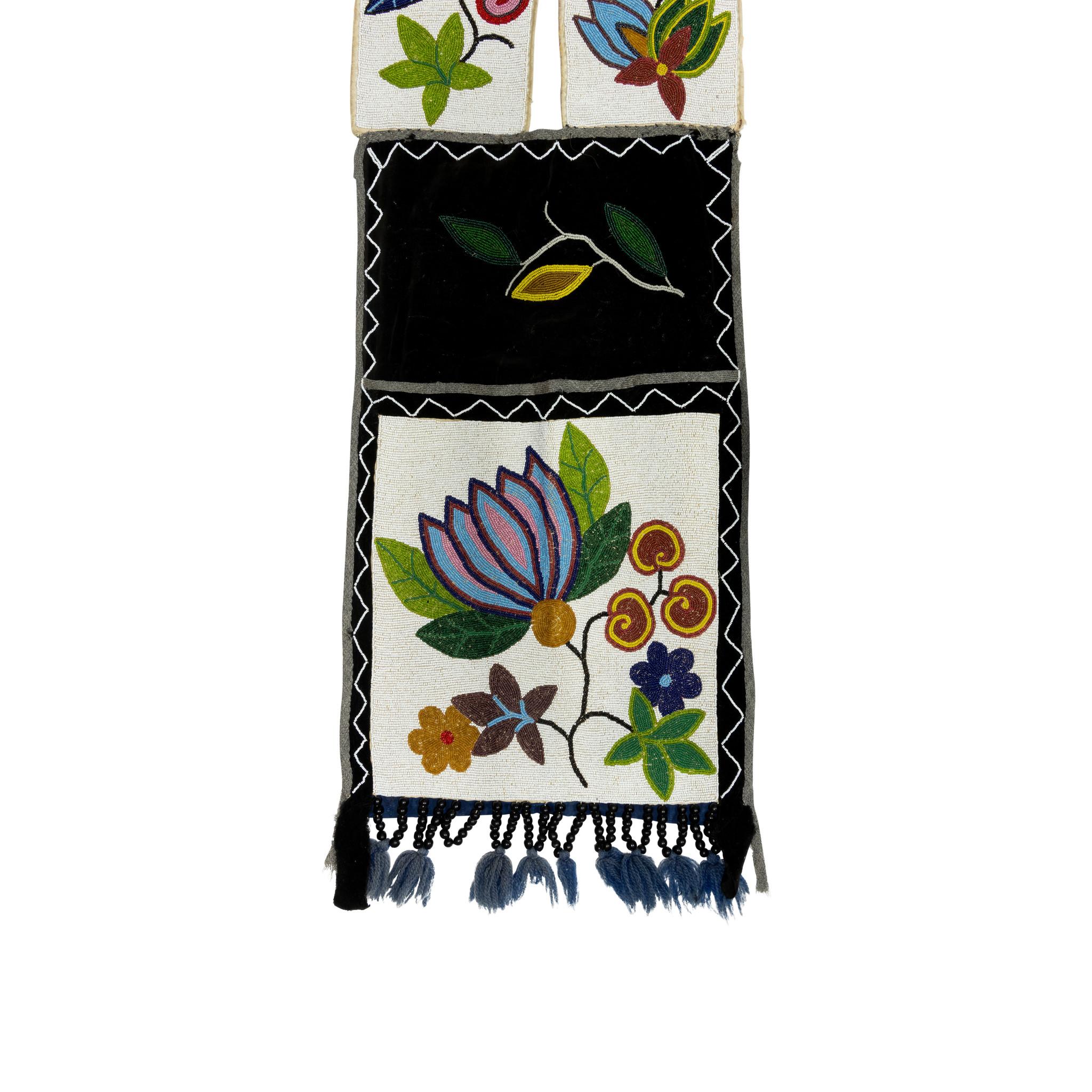 Extra-large Chippewa beaded bandolier bag with full pocket. Black bead drops ending in blue yarn. Bright and visual vintage piece of Native American beadwork. Makes a great wall hanging. 

Period: 19th century
Origin: Chippewa
Size: 14