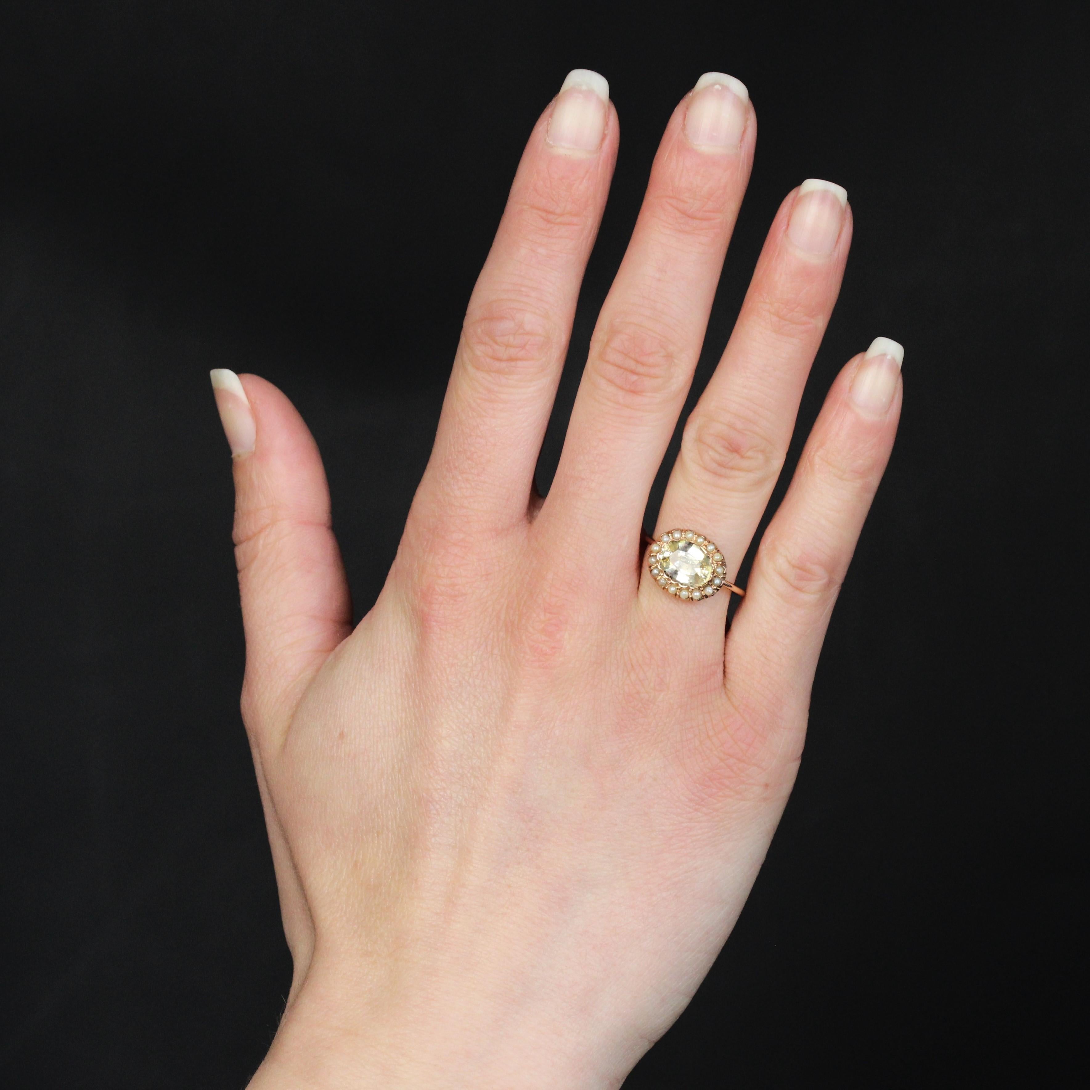Ring in 18 karat rose gold.
A feminine antique ring, its band is a round gold wire supporting an oval-shaped basket adorned in the center with a scalloped closed setting of an oval-shaped natural yellow sapphire. Fine half-pearls surround the