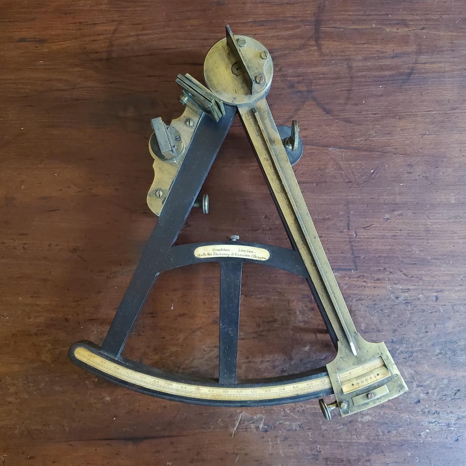 Early 19th century Naval Navigational Octant by John Crichton (London) in Original Case, circa 1830s, an ebony frame quadrant with brass mounted lens, mirror, shades, index arm, hinge and feet, with bone calibrated scale and maker's plaque inscribed