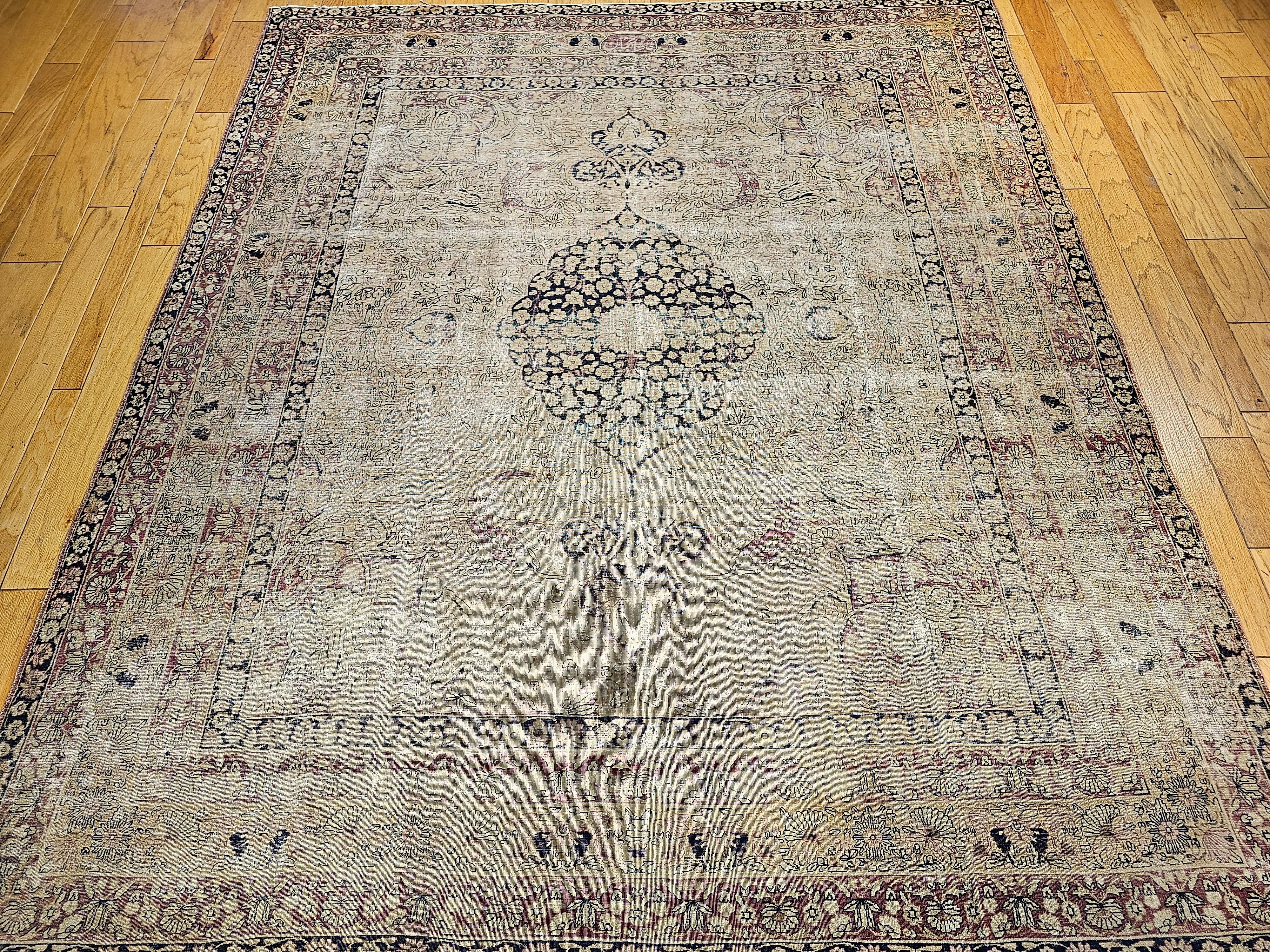 A rare near square size Persian Kermanshah circa the 3rd quarter of the 1800s.  The beautiful Persian Kermanshah has a “distressed’ look and a medallion floral pattern set in an ivory color background.  The design throughout the field and border is