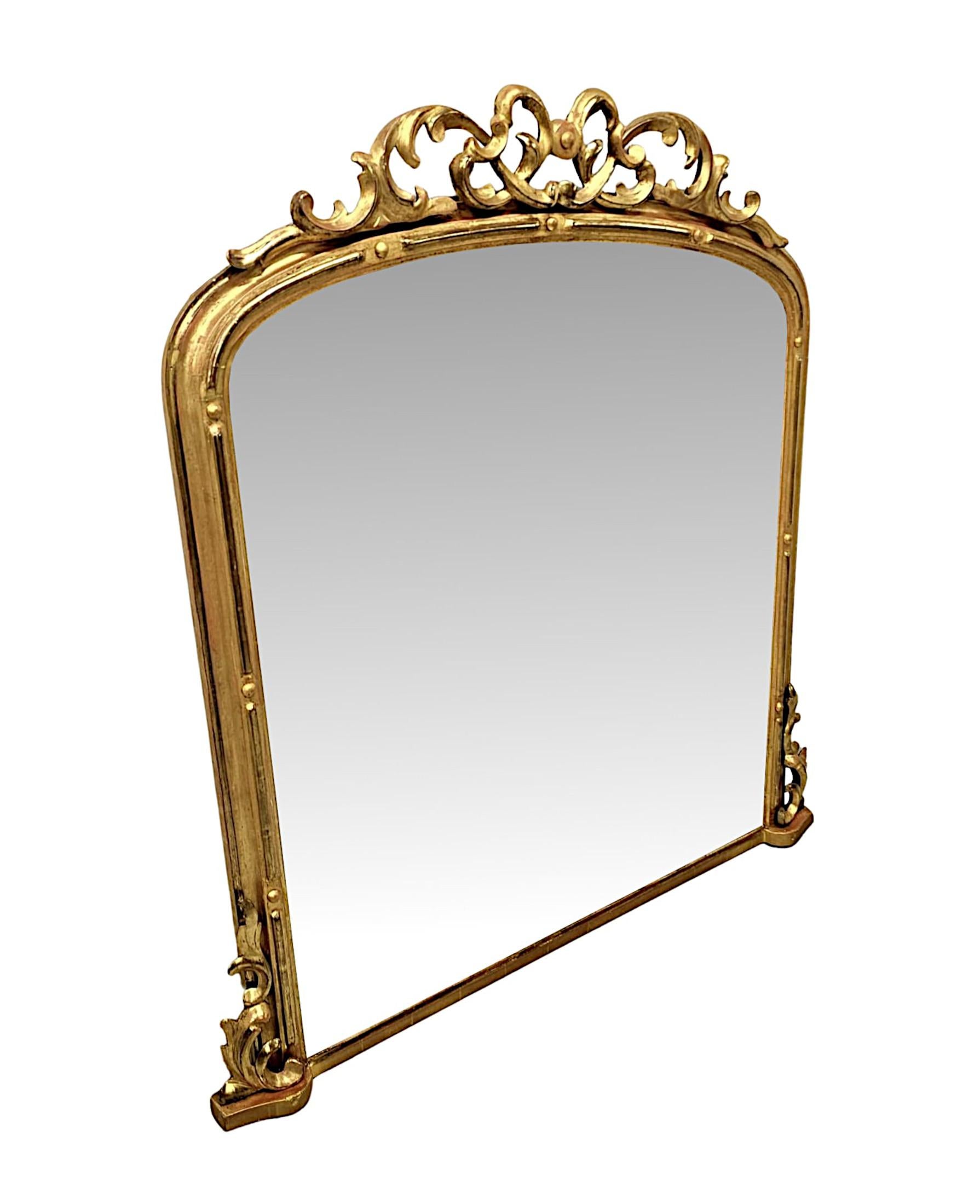 A stunning 19th Century giltwood overmantel mirror of exceptional quality and neat proportions.  The shaped mirror glass plate of archtop form is set within an elegantly simple and finely hand carved moulded and pierced giltwood frame with sphere