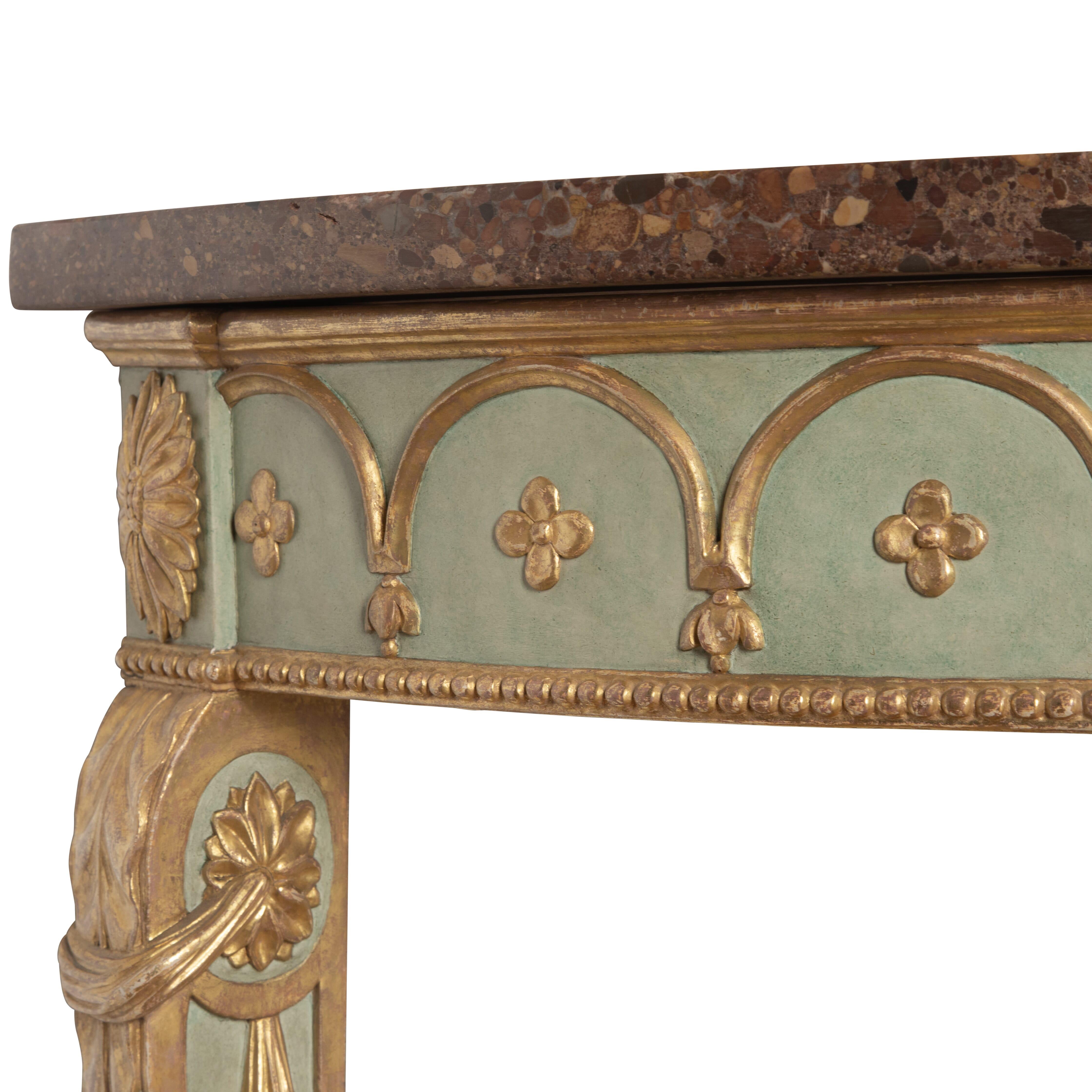 ﻿ A fabulous mid C19th neo-classical semi elliptical carved giltwood console/side table, finished in gilt and colourful decoration, after a design by Robert Adam. The colourful marble top with no breaks or damage, above a frieze with a carved arched