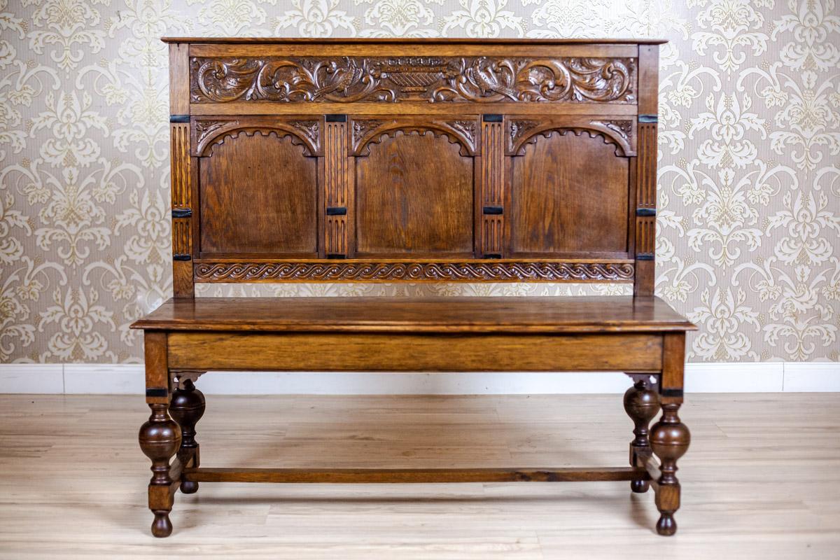 We present you an oak Neo-Renaissance bench from fourth quarter of the 19th century.
The whole piece of furniture is placed on turned legs, which are joined together with a straight stretcher.
Furthermore, the three panels that divide the backrest