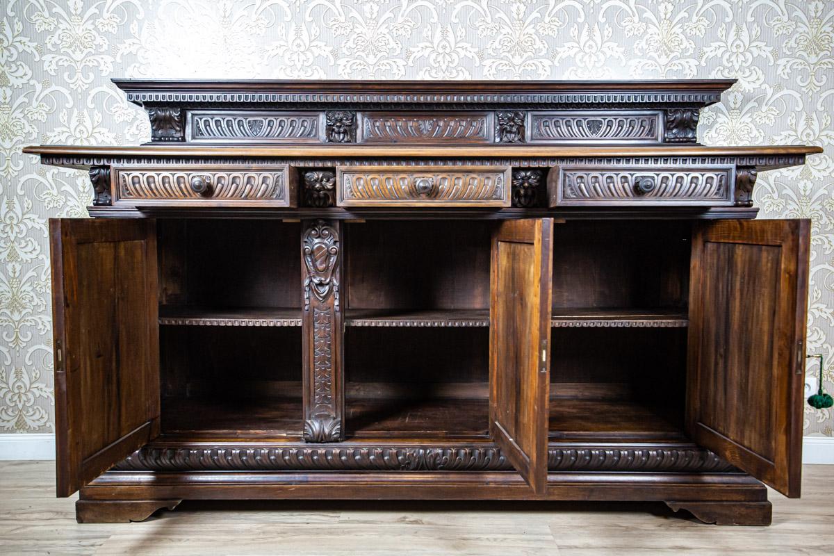 19th-Century Neo-Renaissance Oak Sideboard in Deep Brown

We present you a massive Neo-Renaissance oak sideboard from fourth quarter of the 19th century.
The three-door base has three drawers on the axis and structural divisions.
The add-on unit is