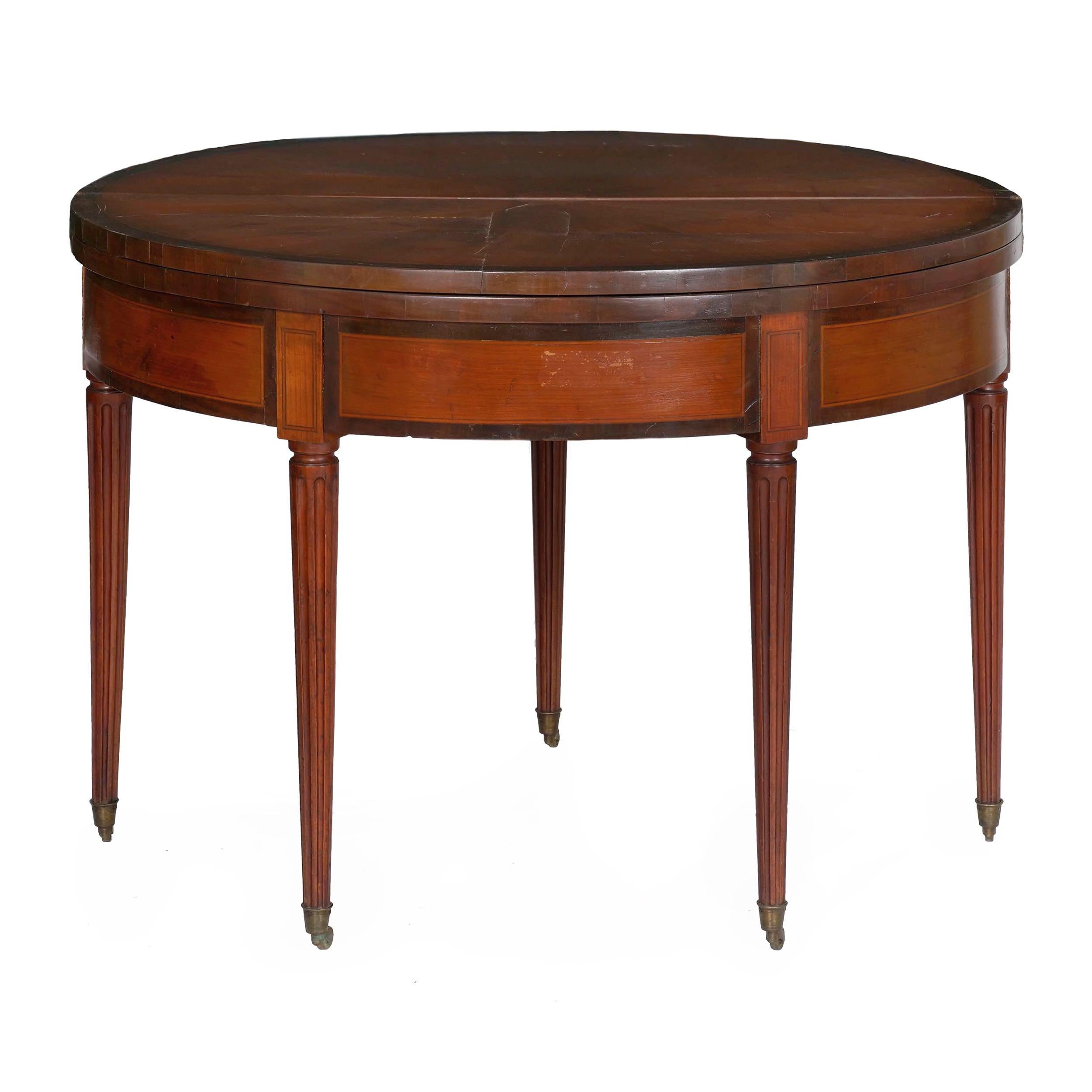 An interesting table for its sheer versatility, this delightful table is first a console in demilune form, second opening up to a perfect circle as a games table and finally opening once again into a card table with a green baize playing surface.