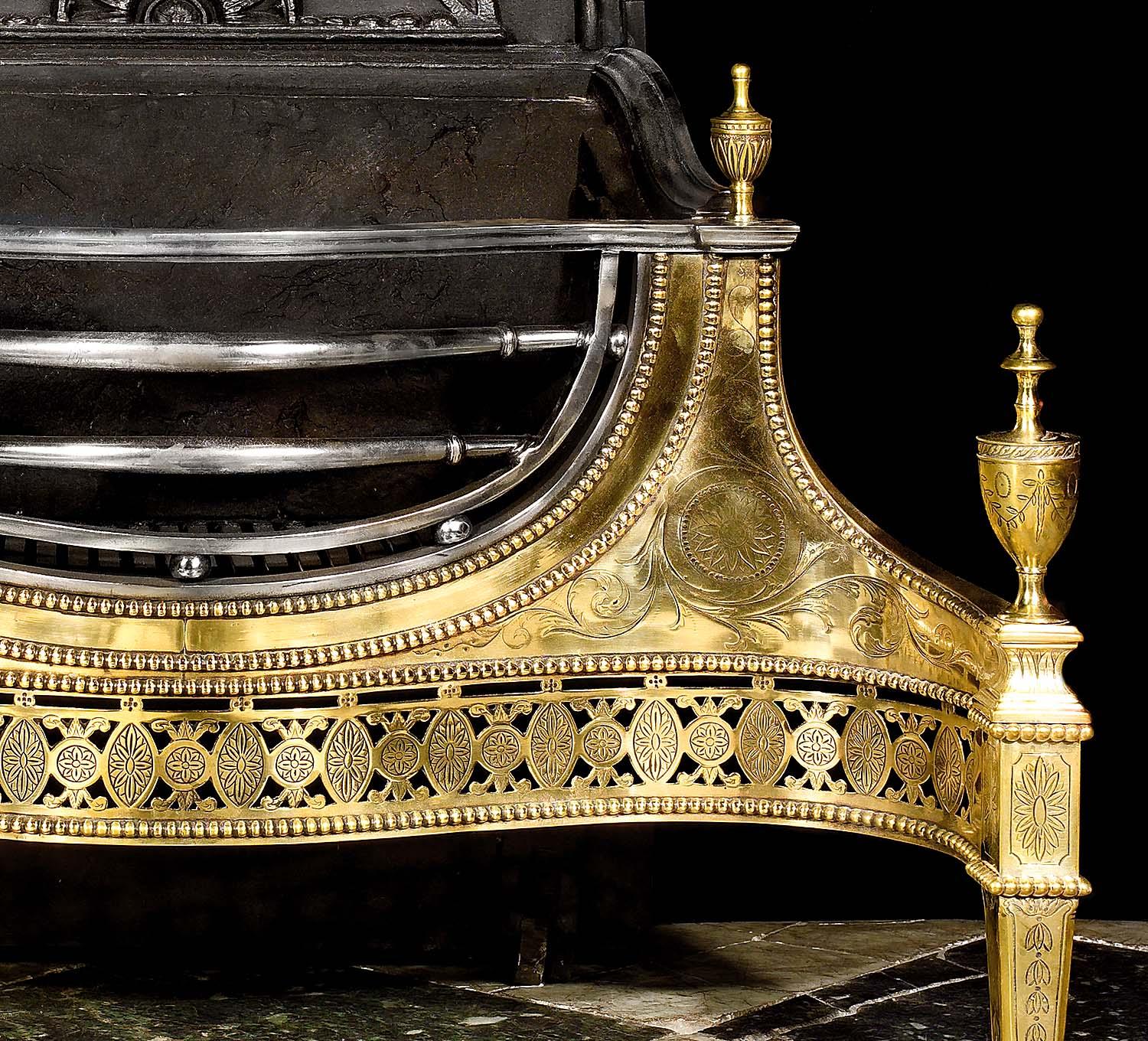 A fine and very large Georgian style steel and brass fire basket in the manner of Robert Adam. The arched backplate, with a central sunburst, sits behind a three bar, bow fronted grate cradled on either side by finely engraved shoulders within a