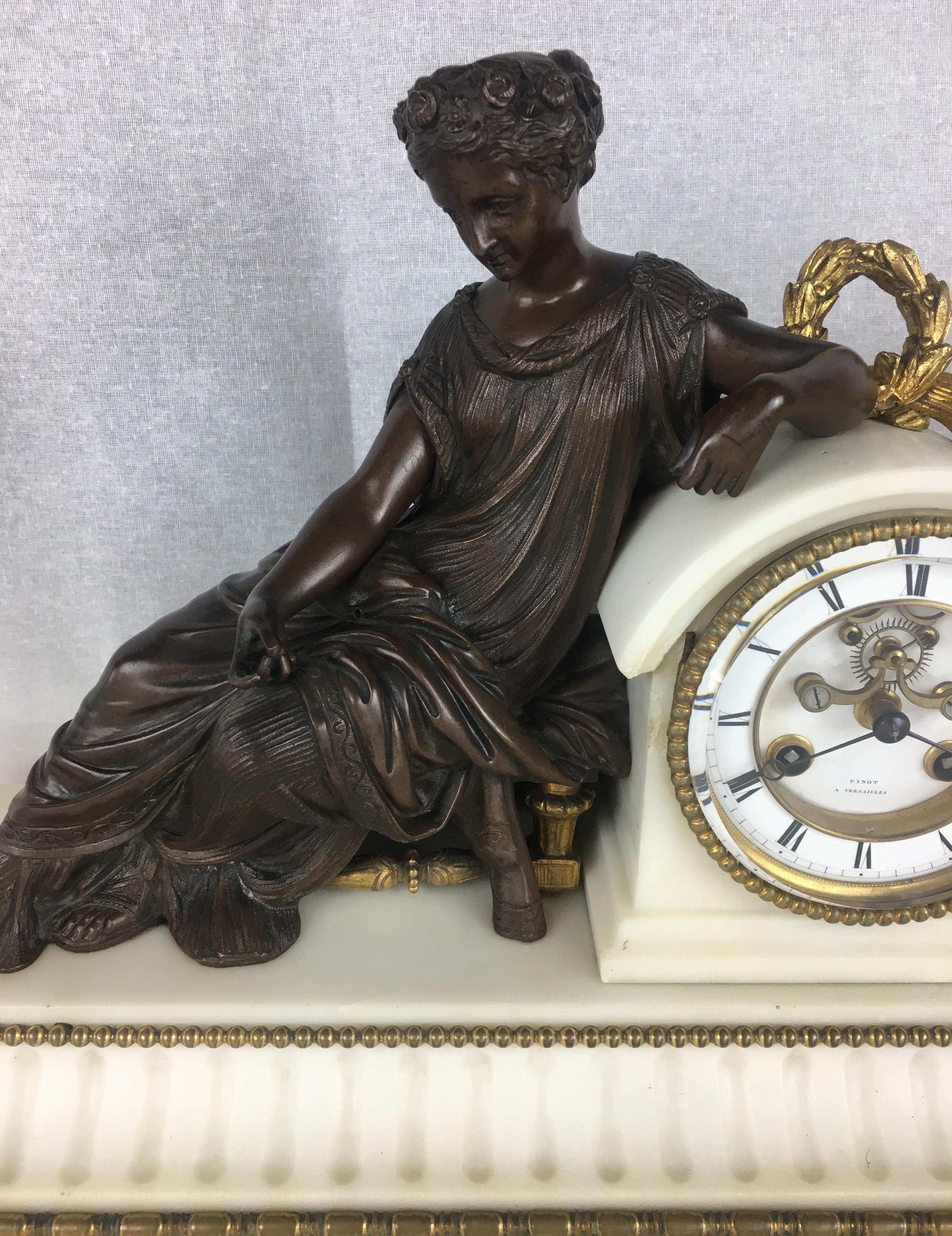 A fine 19th Century French Neoclassical White Marble and Gilded Bronze Mantel Clock Set with its original and exceptional movement. Bears the makers mark, Finot a Versailles. The dial supporting a reclining bronze classical muse on a rectangular