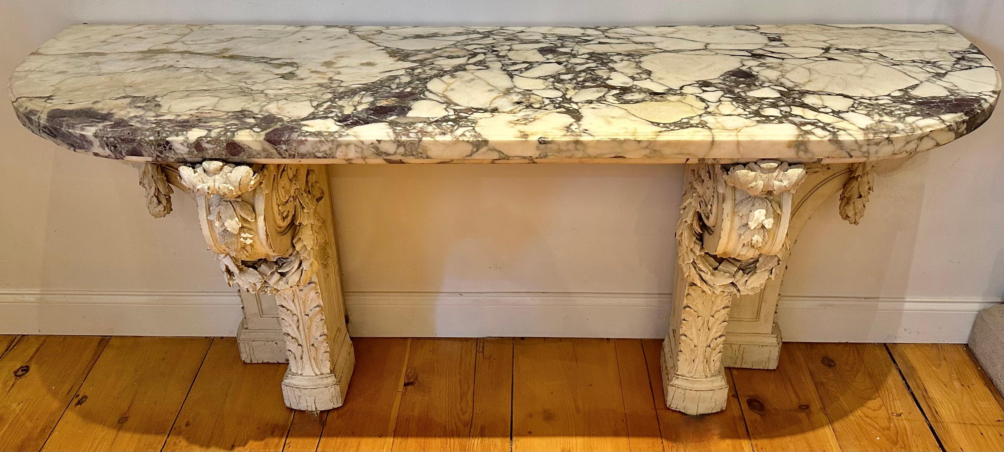 Magnificent 19th Century Louis XVI Neoclassical Marble and Carved Wood Console Table.  Brescia Violeta Marble Top.  Beautifully carved wooden painted pedestals of laurel swags.  Quite substantial with great presence.

Provenance:  Private