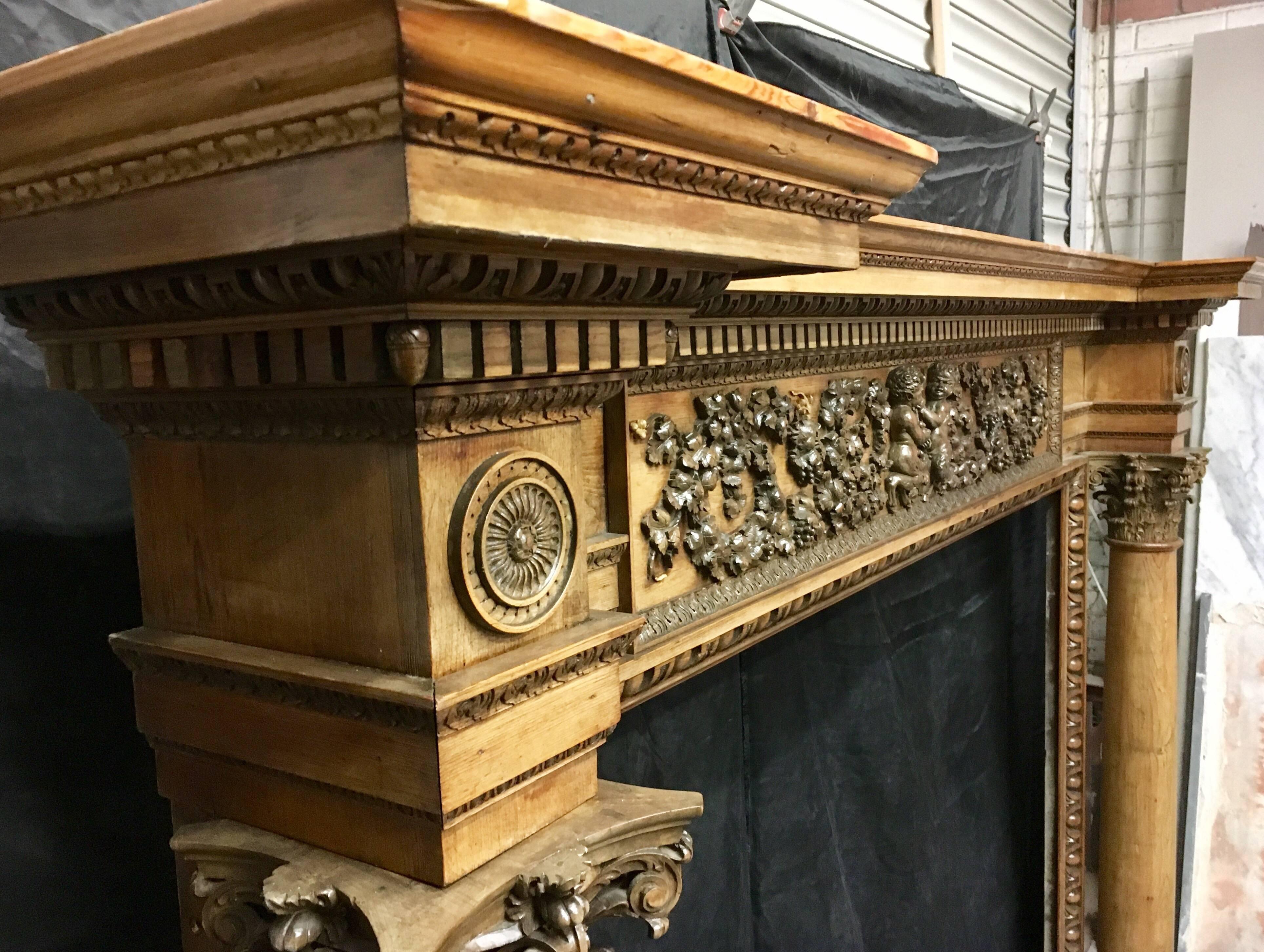 A substantial and impressive architectural late 19th century profusely carved pine and lime wood fireplace surround in the Georgian manner of Robert Adam. The shelf perfectly evokes the cornice of a Corinthian entablature above a frieze comprising,