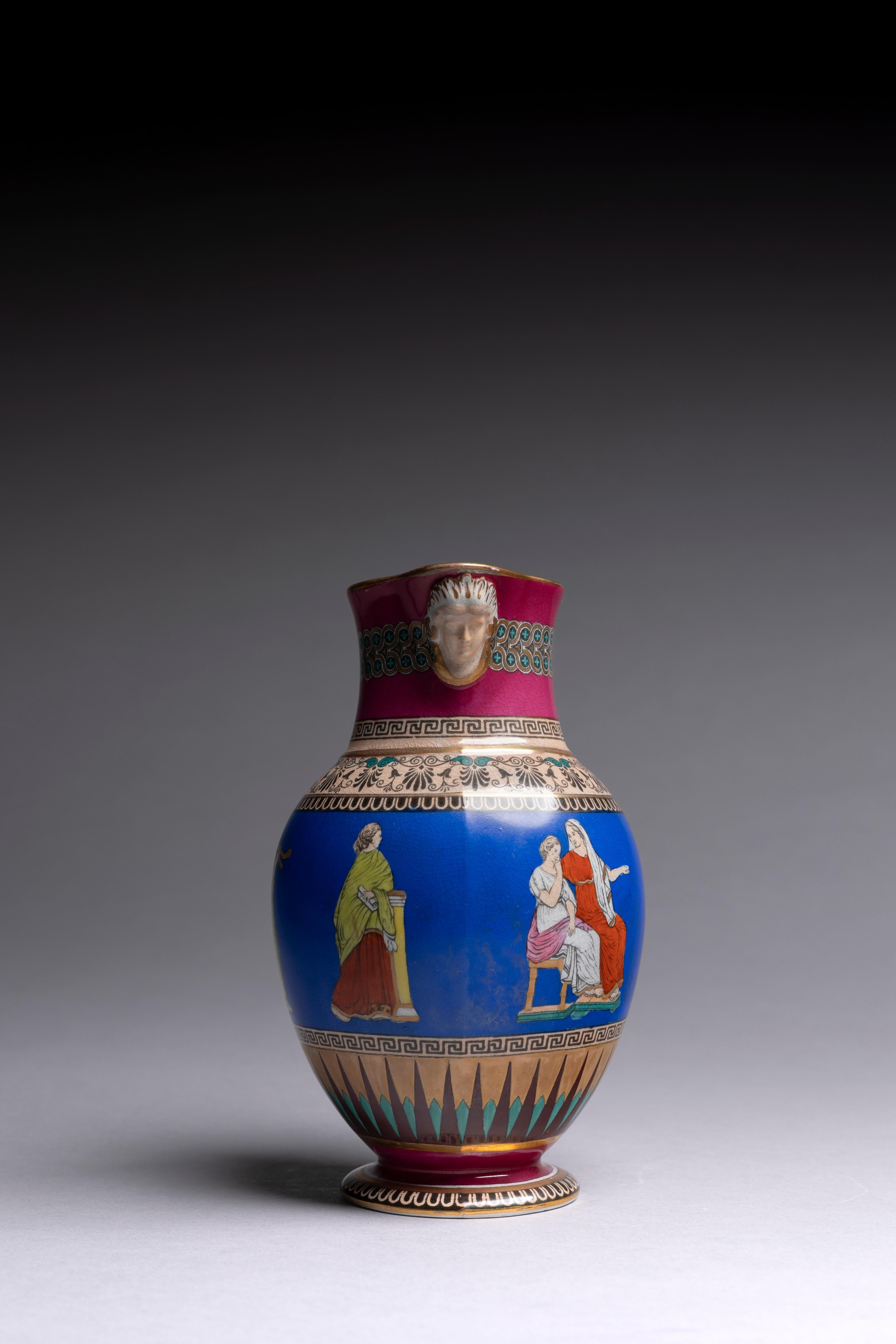 A brightly colored English Neoclassical pitcher, made circa 1850 by Samuel Alcock & Co. The pitcher is glazed with lively colors--burgundy, cerulean, teal, peach--all accented with fine gilding. The transferware pattern depicts scenes from the