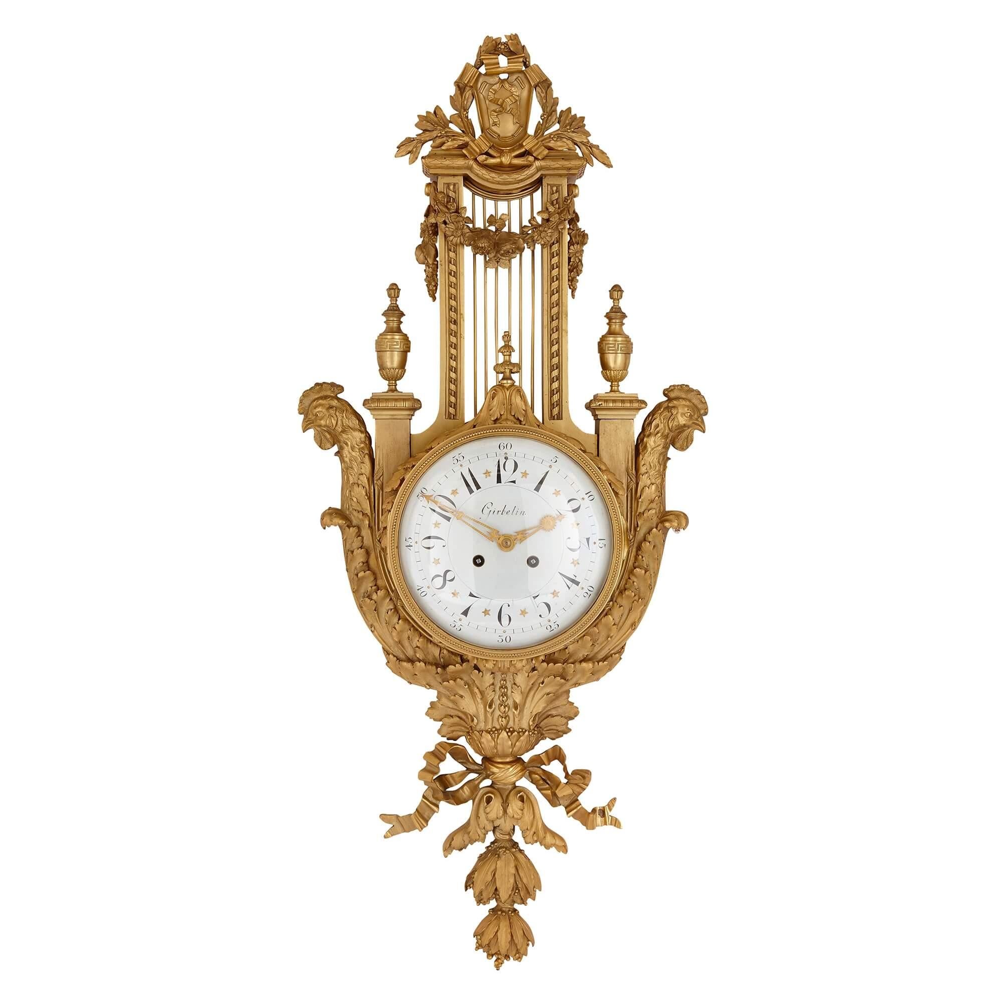 This fine set comprises a cartel clock and barometer, each of which are crafted entirely in gilt bronze. The clock and barometer cases are identical, and take the form of a lyre. The circular dials are set to the centre, within the body of the