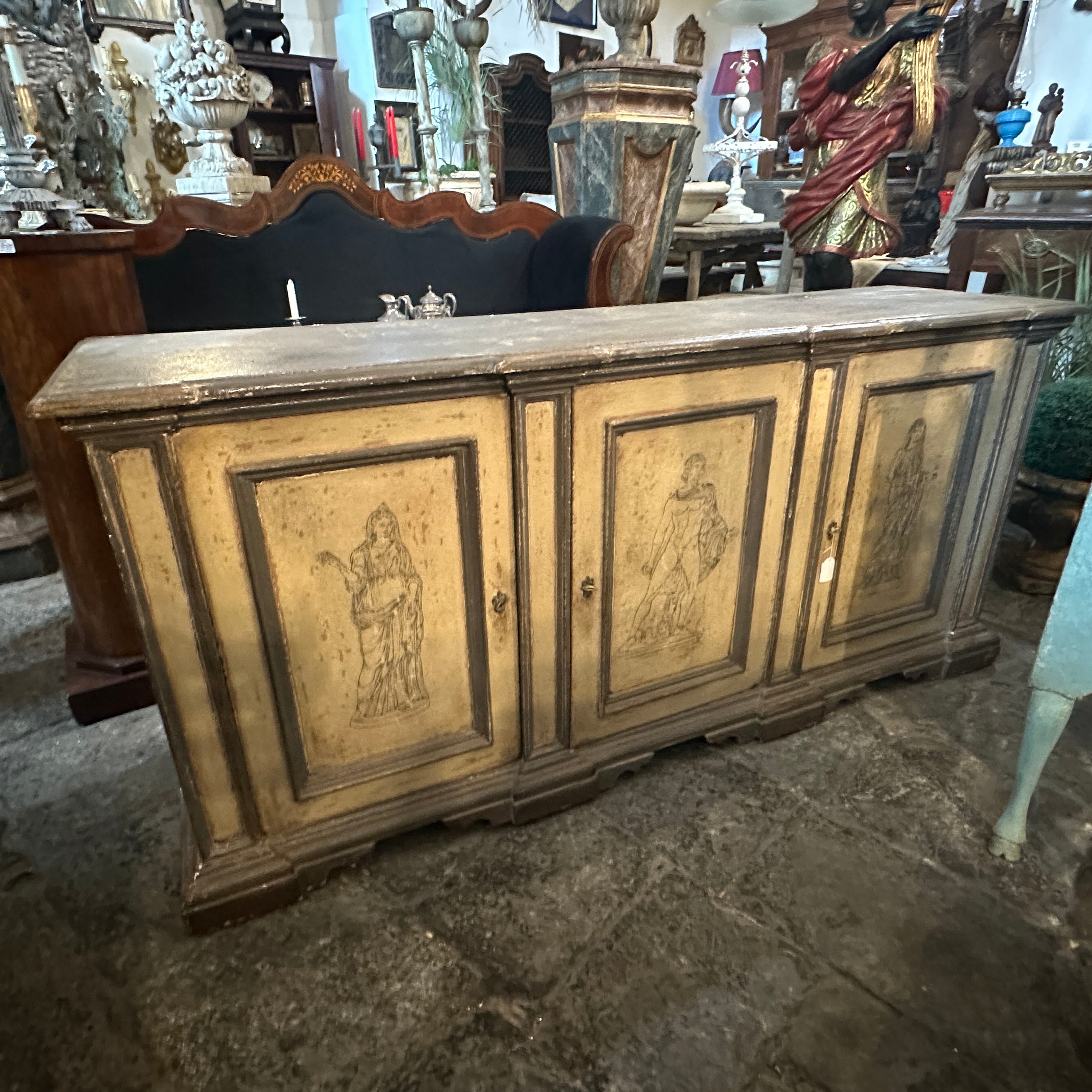 A gray and white ivory lacquered wood credenza hand-crafted in Italy in late 19th century in a neoclassical style, the three decors depict three statues of Pompei. The credenza features characteristics associated with the Neoclassical design