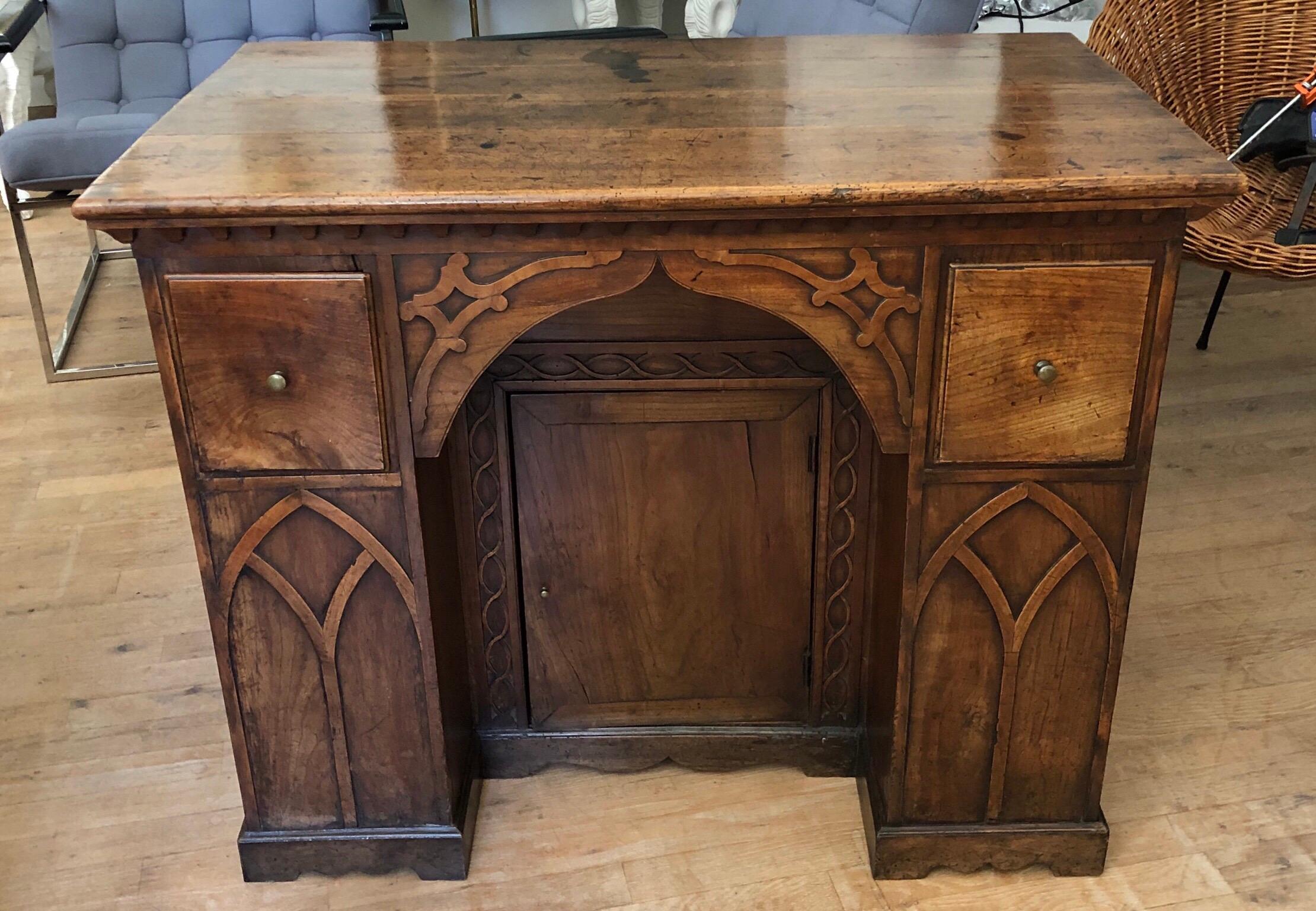 19th century neogothic fruitwood kneehole desk... Beautifully and thoughtfully restored.
It makes a great nightstand due to its diminutive scale.