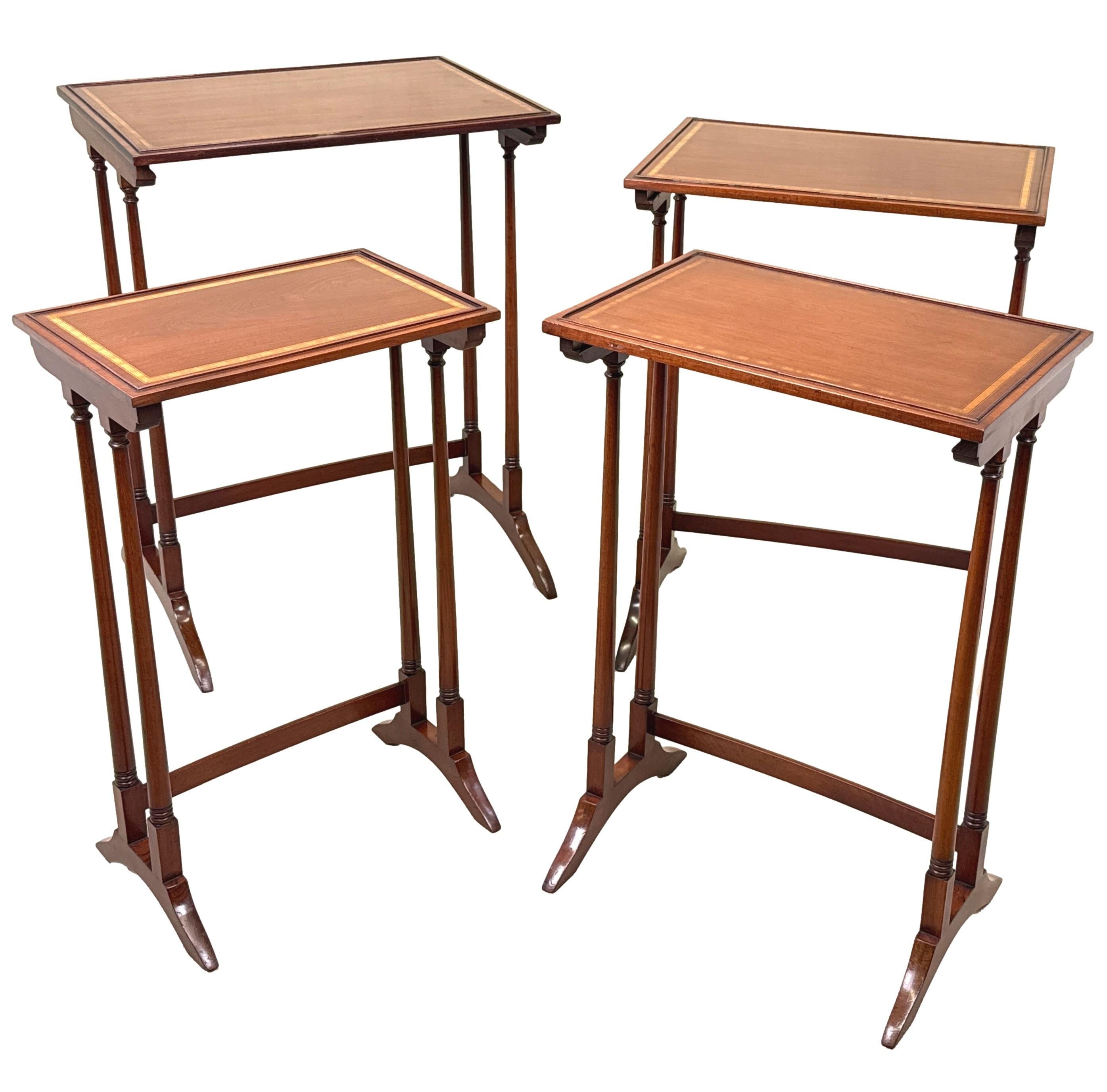 A Good Quality Late 19th Century Mahogany Quartetto Nest Of Four Coffee Tables, Having Well Figured Rectangular Tops With Satinwood Banded Decoration And Cockbeaded Mouldings, Raised On Elegant Turned Upright Supports, United By Cross Stretchers And