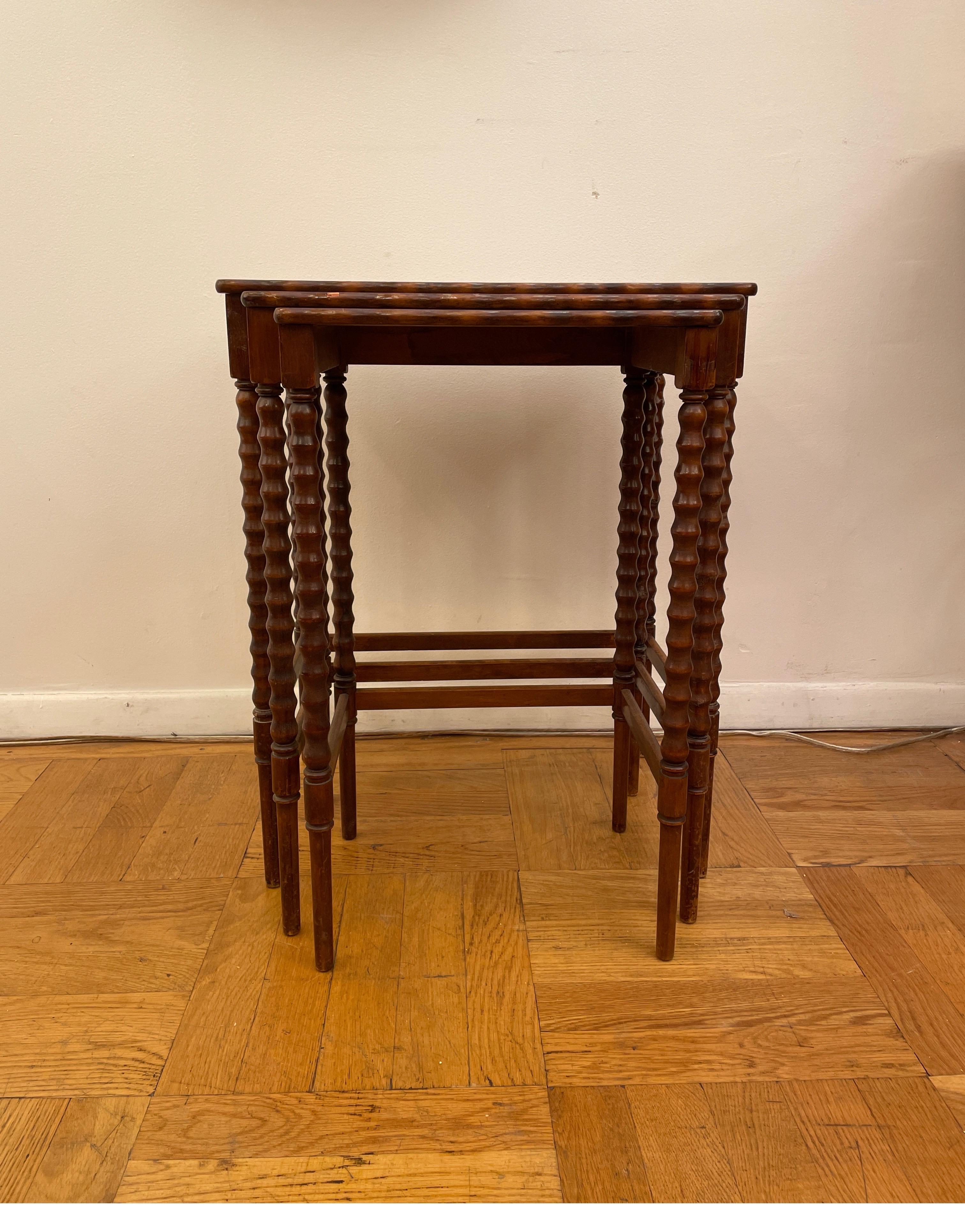 Lovely set of nesting antique tables with highly sought after barley twist legs and bevelled edge tops borrows classical forms with modern taste and convenance. Still practical and lovely today, these tables stand as a homage to generations of
