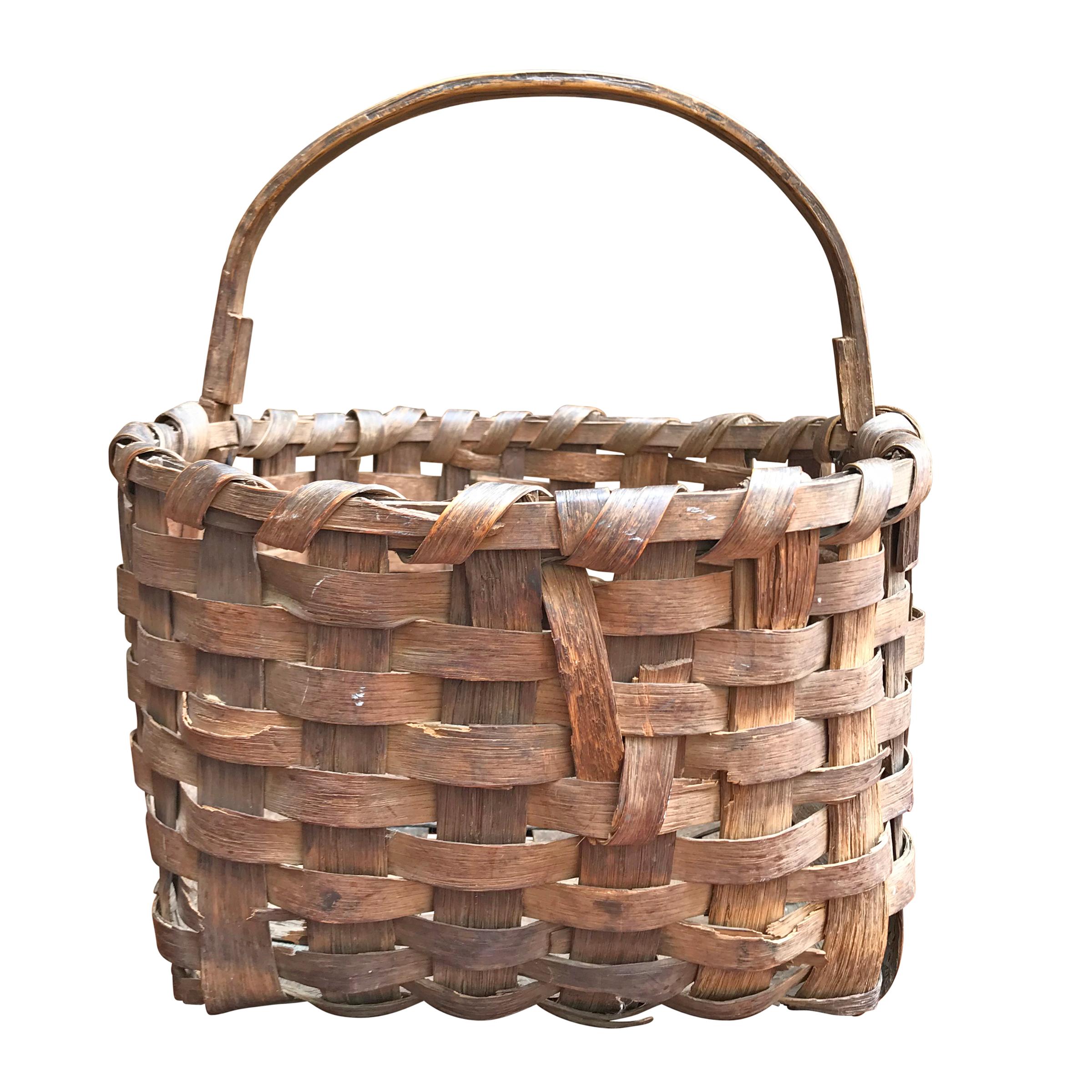 A sweet 19th century splint oak gathering basket with a single bentwood handle and a wonderful patina. Found in New England.