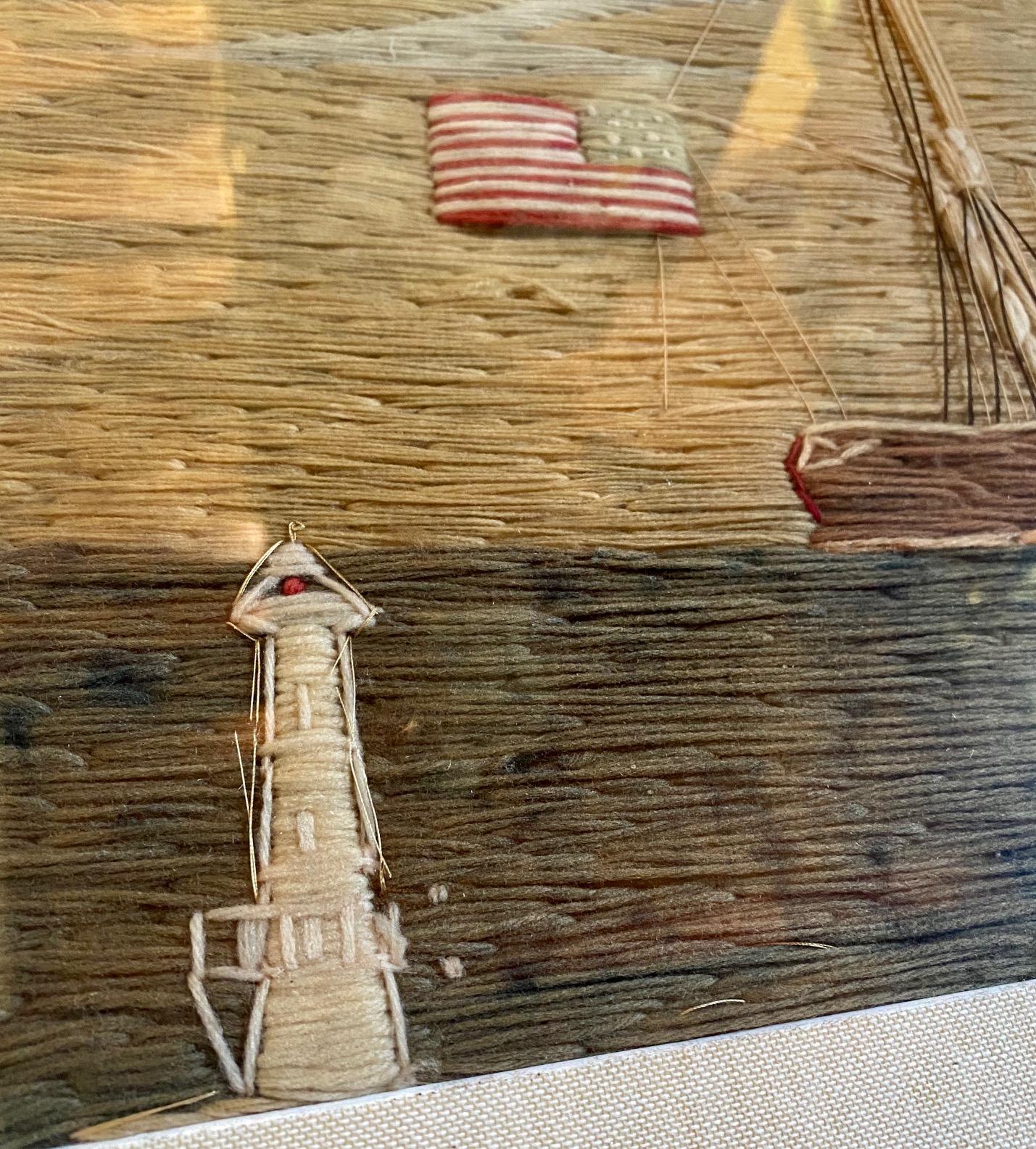 Rare 19th century American Sailor’s Woolie, from New England, circa 1850, with Three Masted Tern Schooner under furled sails, with American ensign flying astern and house flags and pennants aloft, moored in passage between two lighthouses (most