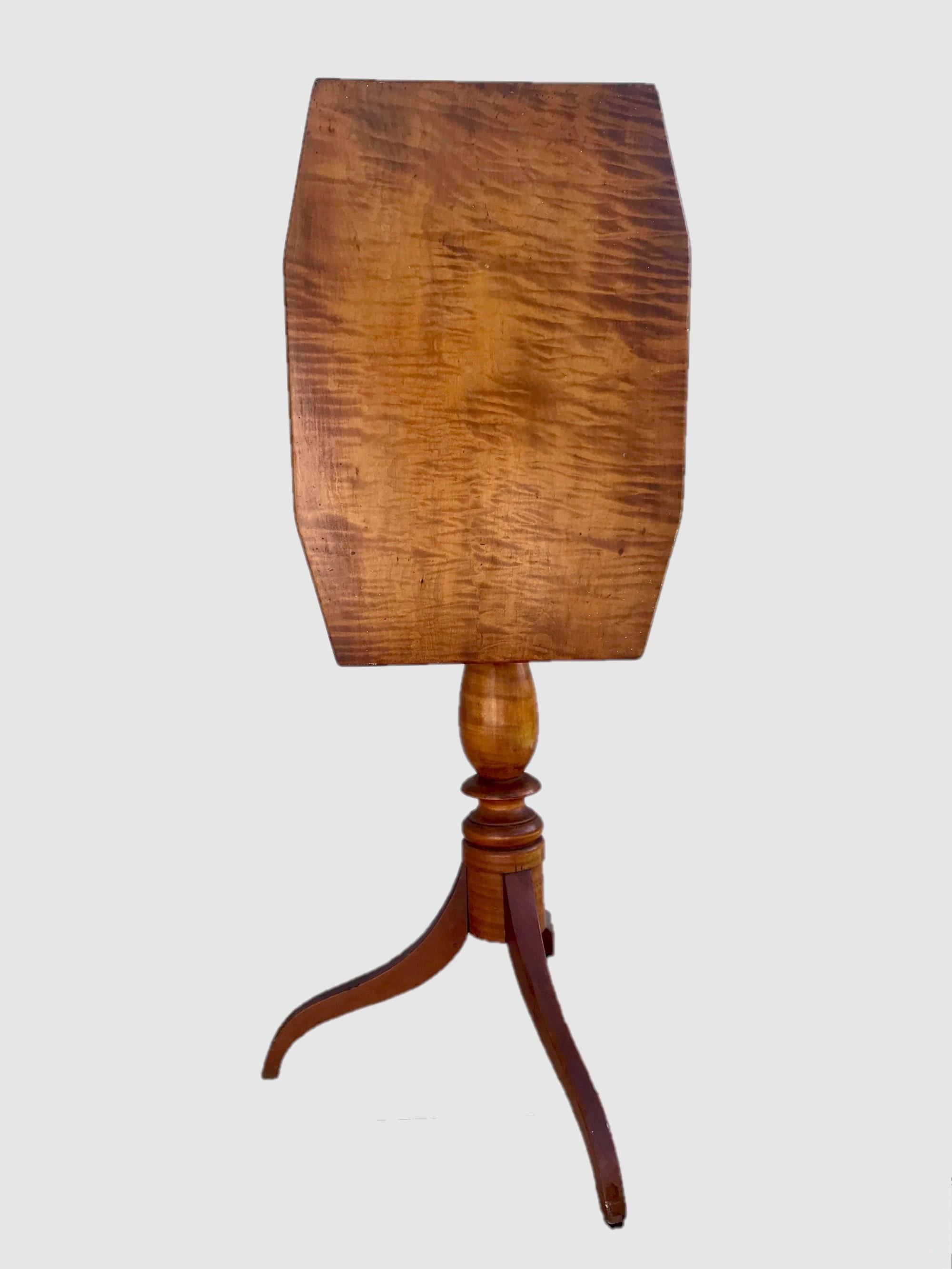 New England Federal tilt-top tripod table tiger maple, circa 1810

Beautiful American tripod tilt-top candle stand table. It was created during the Federal era circa 1810 in New England and constructed with tiger maple wood. This well balanced and