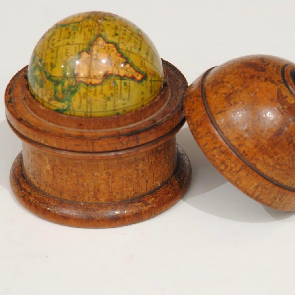A rare fine example of the smallest pocket globe made by Newton and sons with good original colours to the papers. Nicely housed in the original mahogany treen turned case. Measure: 1.5 inch.