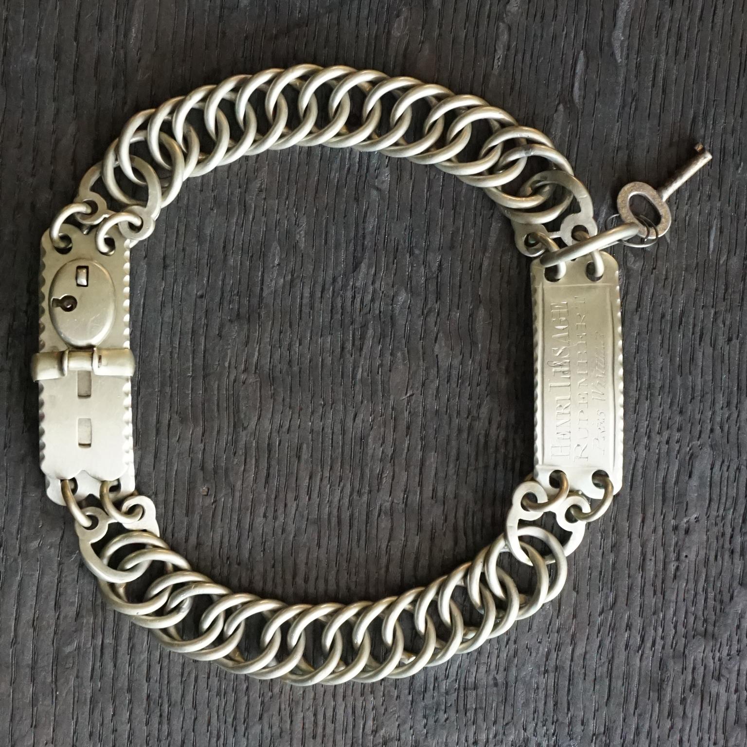 An antique white metal or nickel silver adjustable round double linked collar, probably from a posh French 'Chateau' dog.
With working lock and key and very pretty engraved name tag with owners French address in the North of France near the Belgium