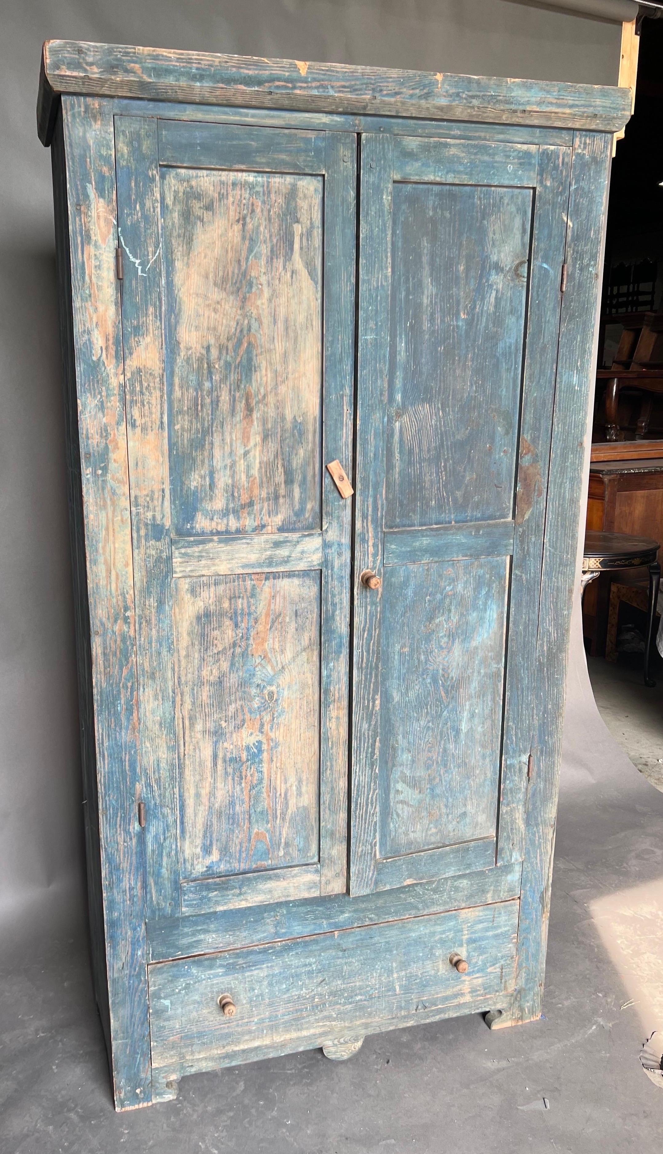 Rare 19th century North Carolina yellow pine press with drawer in original surface. Made of long leaf pine in the Piedmont of NC, this press features pinned construction, a single drawer, a country version of bracket feet and its original blue