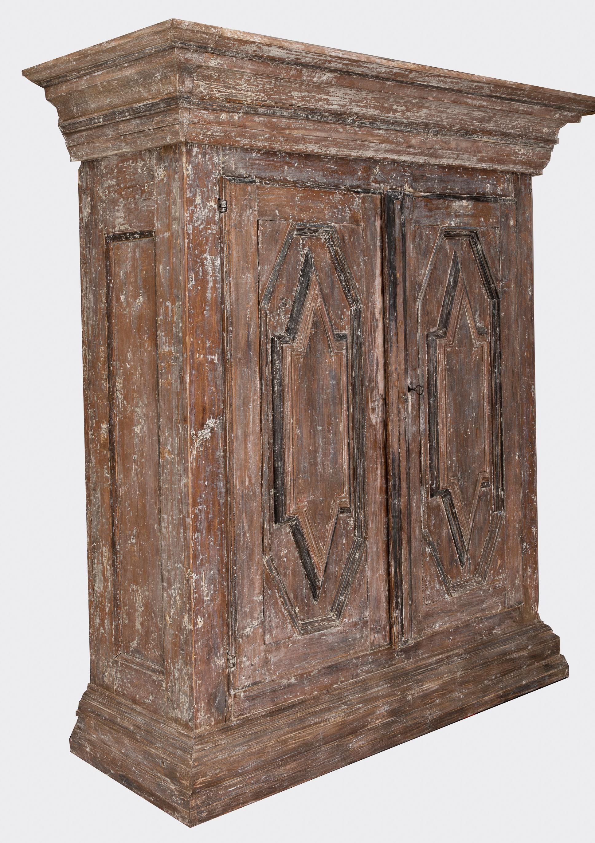 A 19th century Northern European cabinet in the Baroque style, beautifully carved and hand-scraped to the original exterior paint surface. Inside three fixed shelves. Original lock.
   