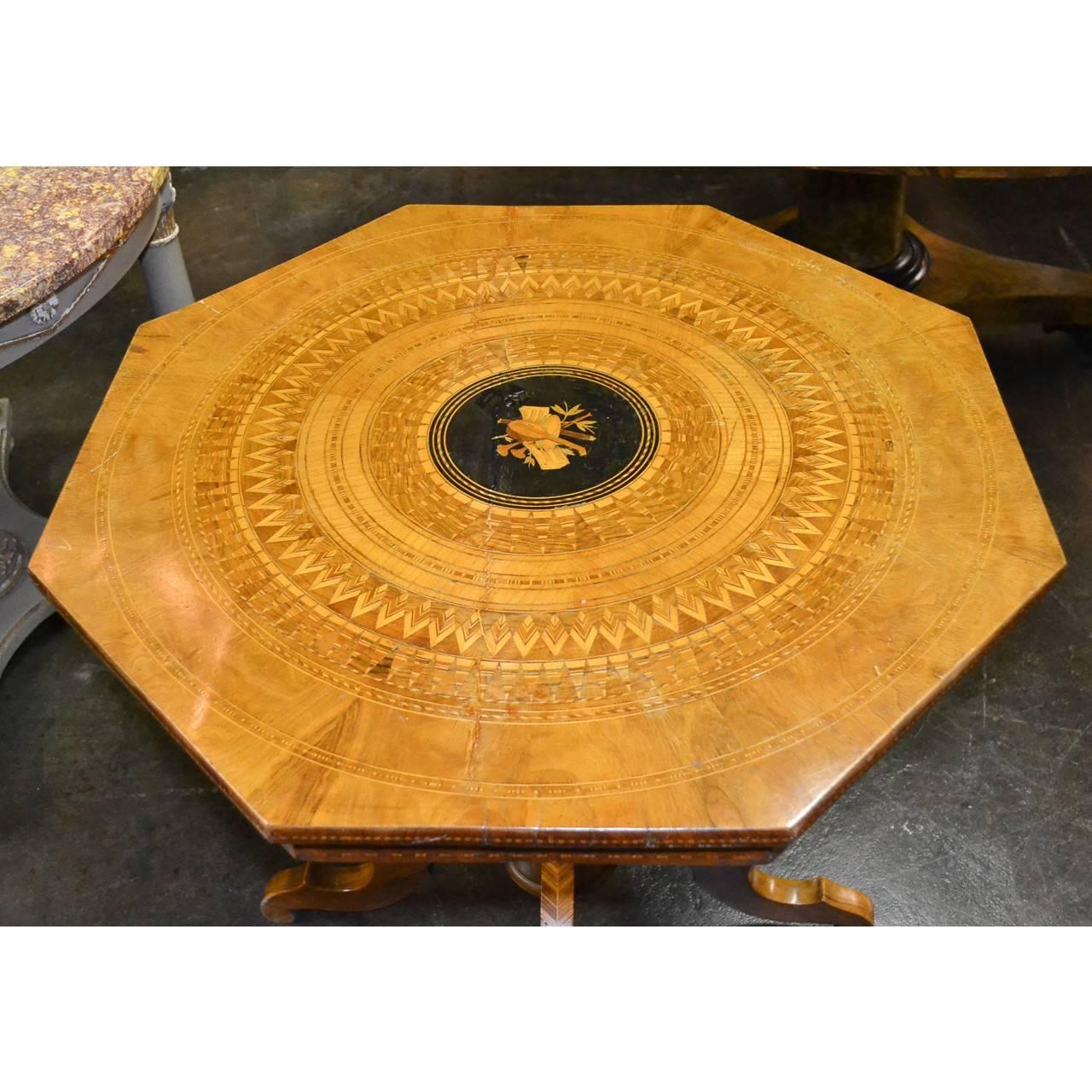 Fine quality 19th century Northern Italian walnut and satinwood parquetry octagonal side table or centre table with remarkable centre inlay depicting sheets of music and a variety of musical instruments. The turned pedestal and tripod base with