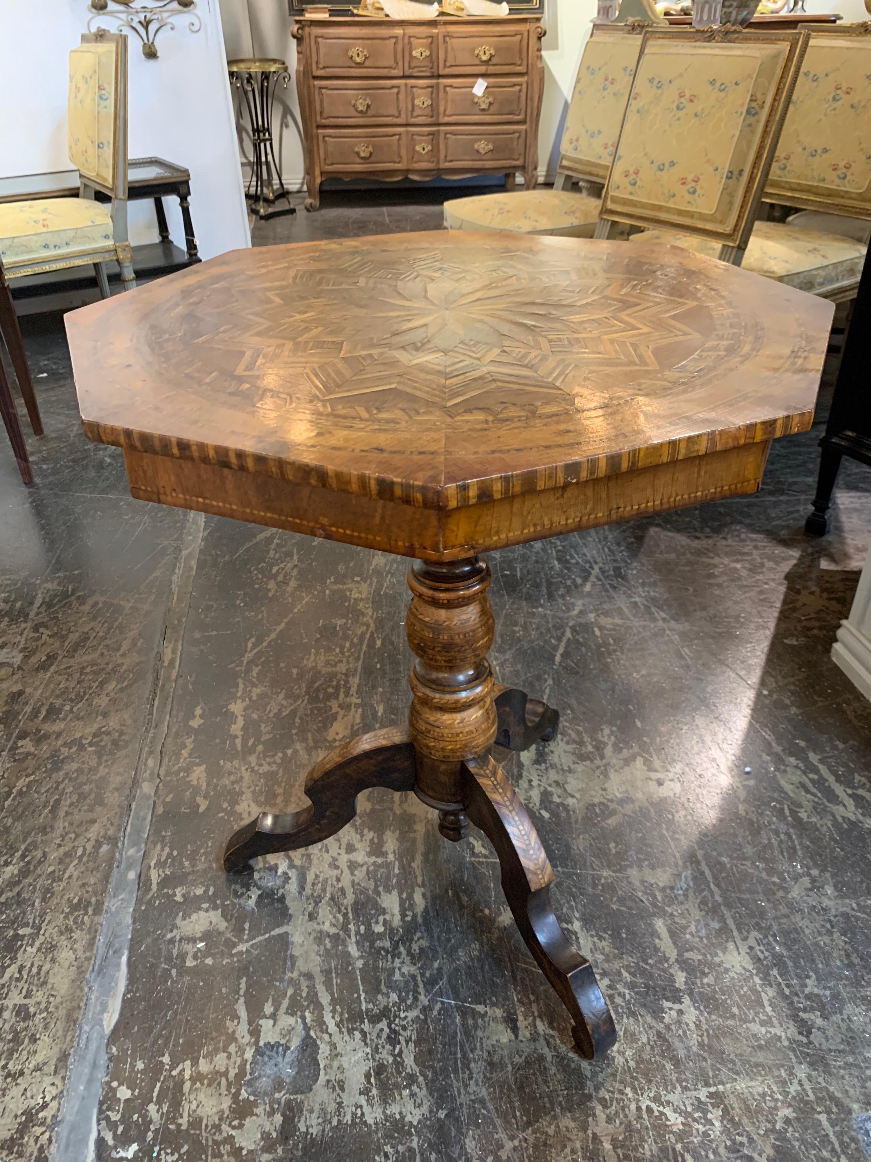 Gorgeous 19th century northern Italian walnut side table. The table has a beautiful inlaid wood in a star pattern. Extremely very fine craftsmanship!
