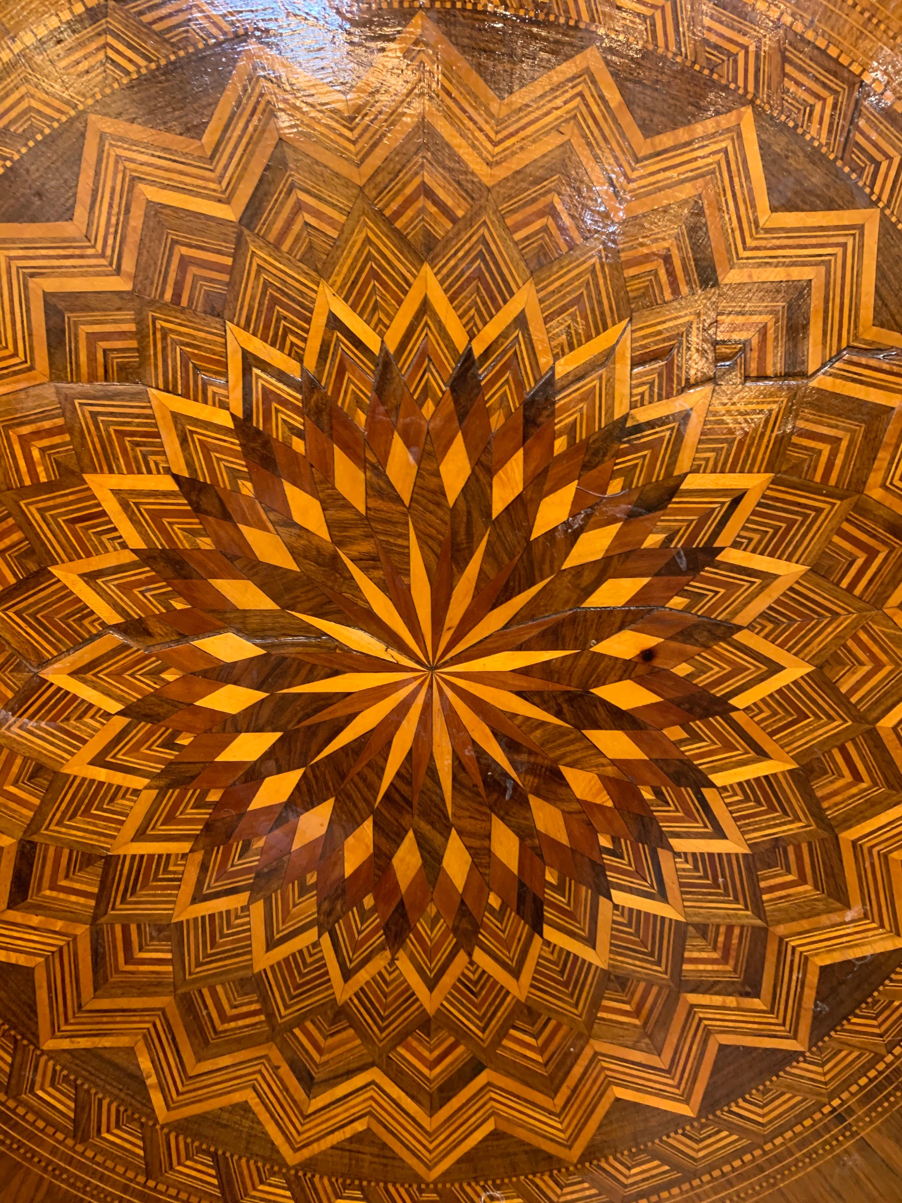 Beautiful 19th century Northern Italian inlaid multi-speciman wood side table. Featuring an amazing intricate star pattern. Very impressive craftsmanship!
Note: There 2 cracks on the outside edge of the table.