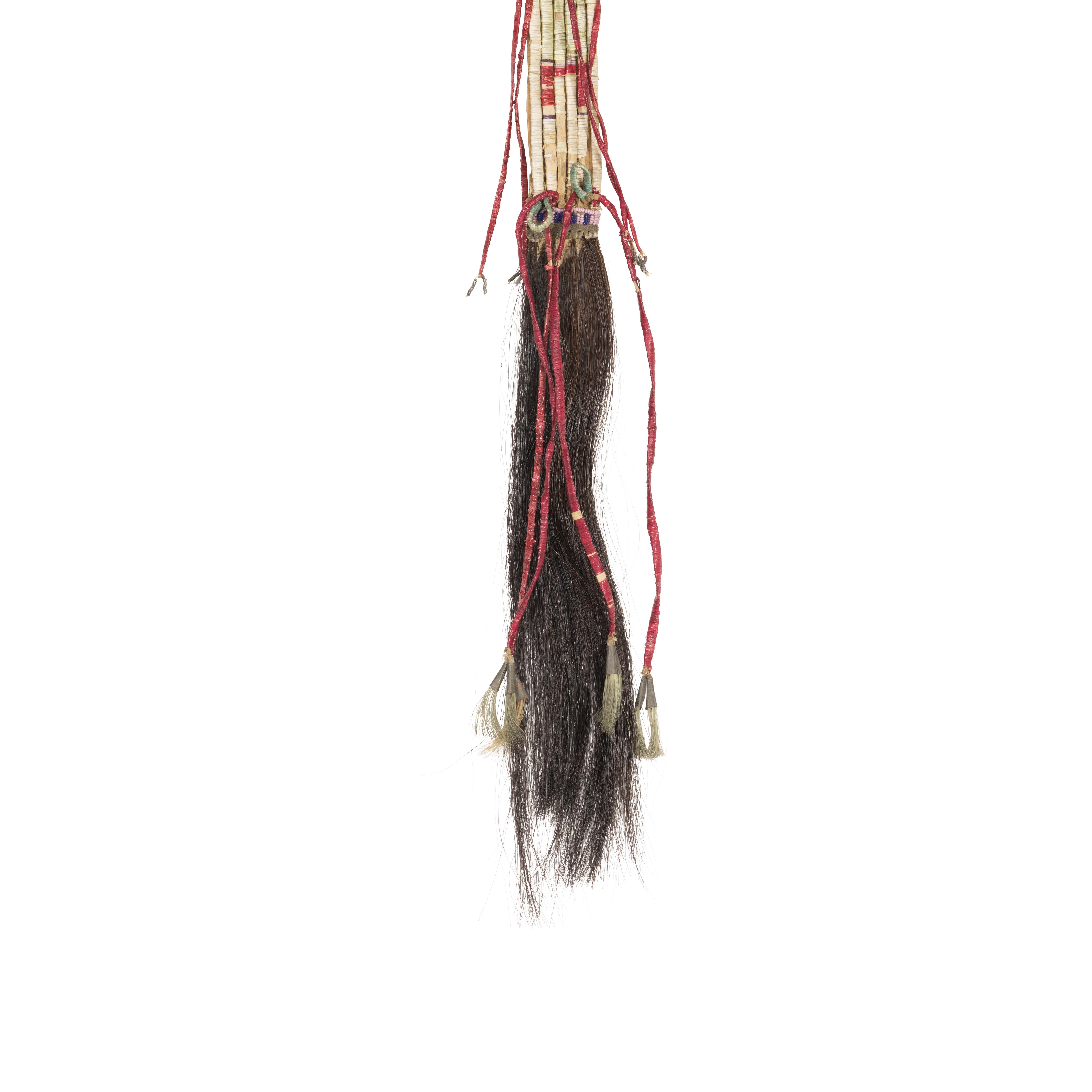 Northern Plains quilled hair drop in white, red and green. Quilled parfleche slats decorated with fully quilled hide thongs ending in tin cones and horsehair. A band of [ink and blue beading at bottom, and black and blue faceted beads at top.