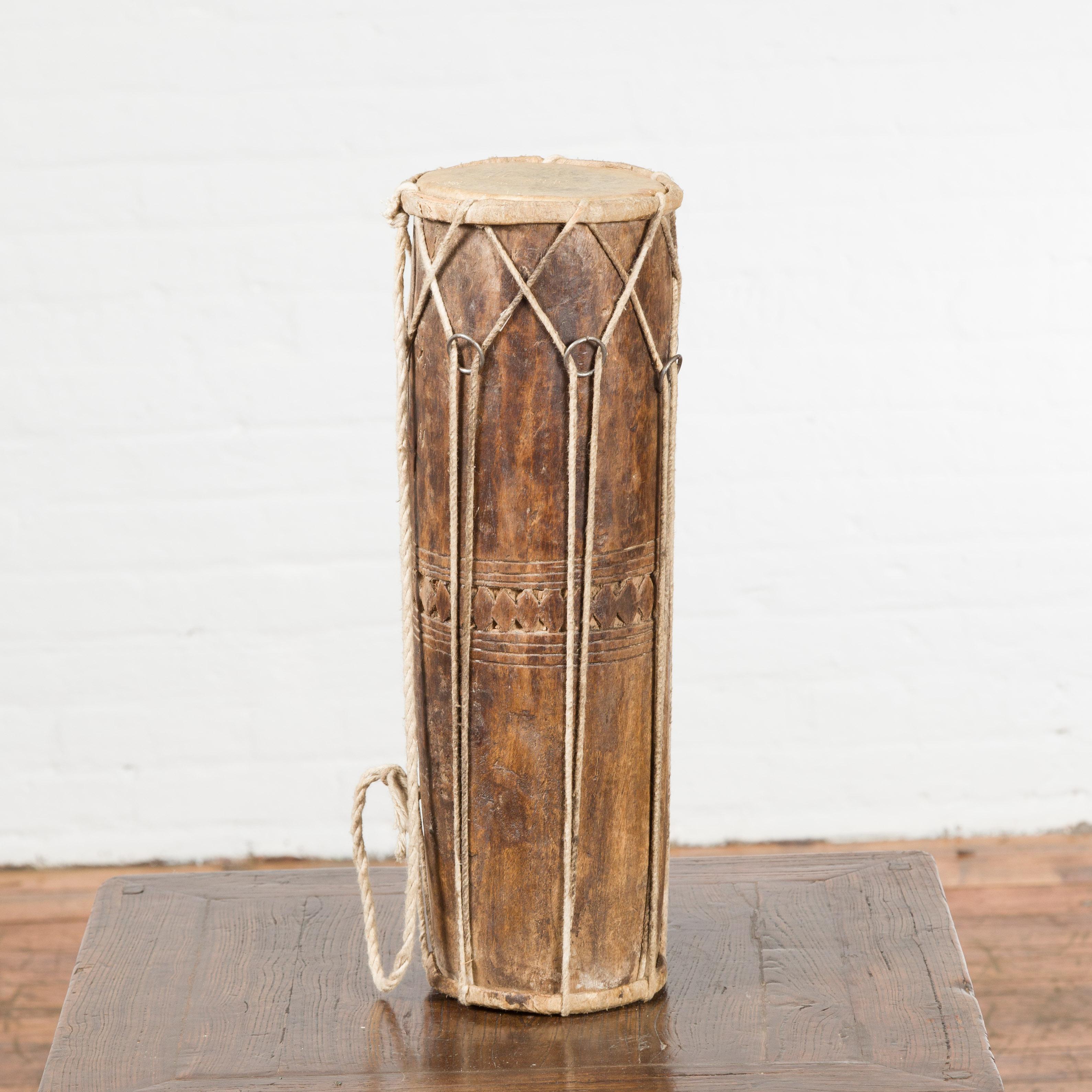 An antique Northern Thai wooden ceremonial drum from the 19th century, with leather drumhead. Sculptural and freestanding, this 19th century drum, created in Northern Thailand, will make for a great decorative accentuation in any home. Topped with a