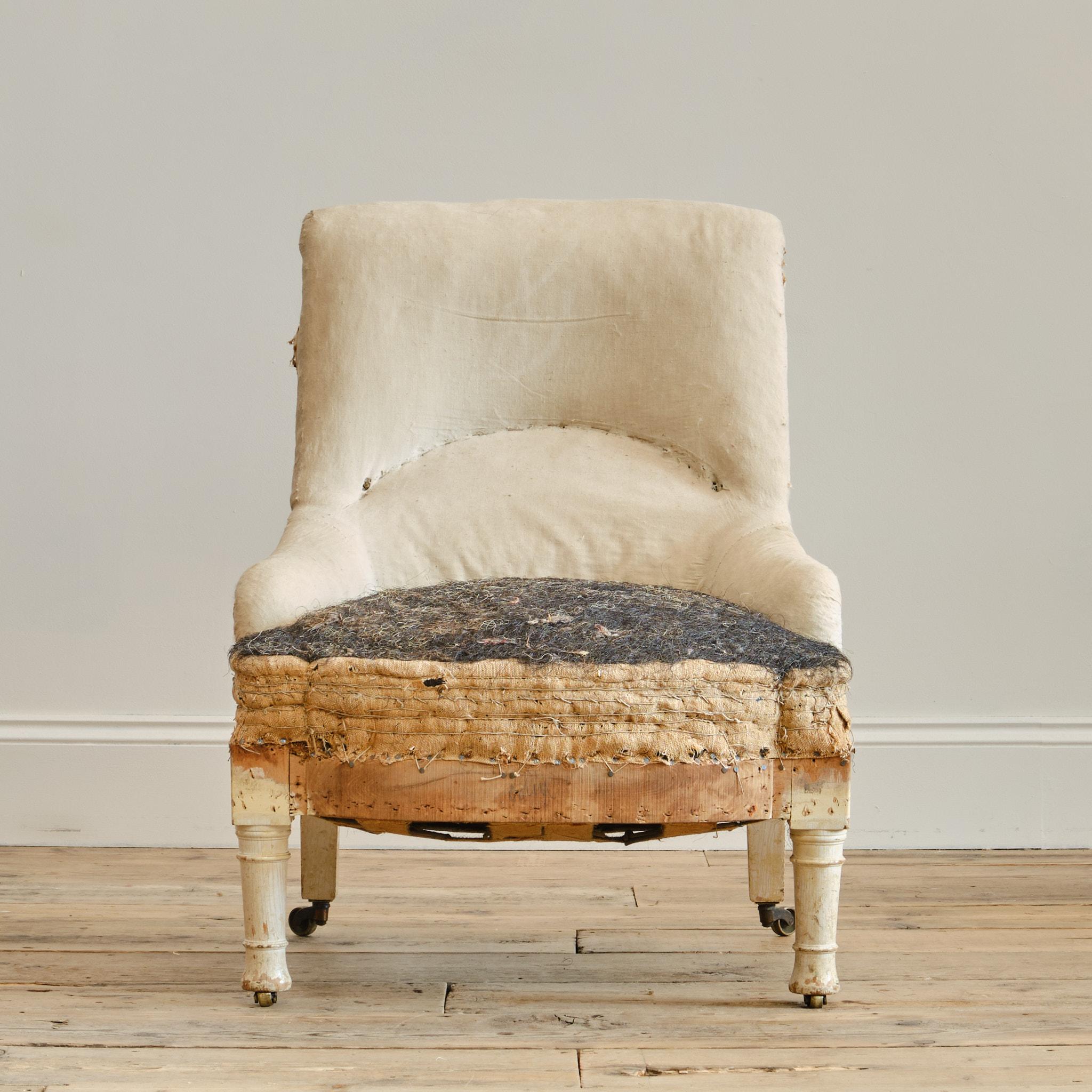 A good quality 19th century bedroom or nursing chair attributed to Gillows c1860. Raised on turned front legs and splayed rear legs. The legs painted in white which is possibly the original finish as the timber beneath appears unfinished. All 4 legs