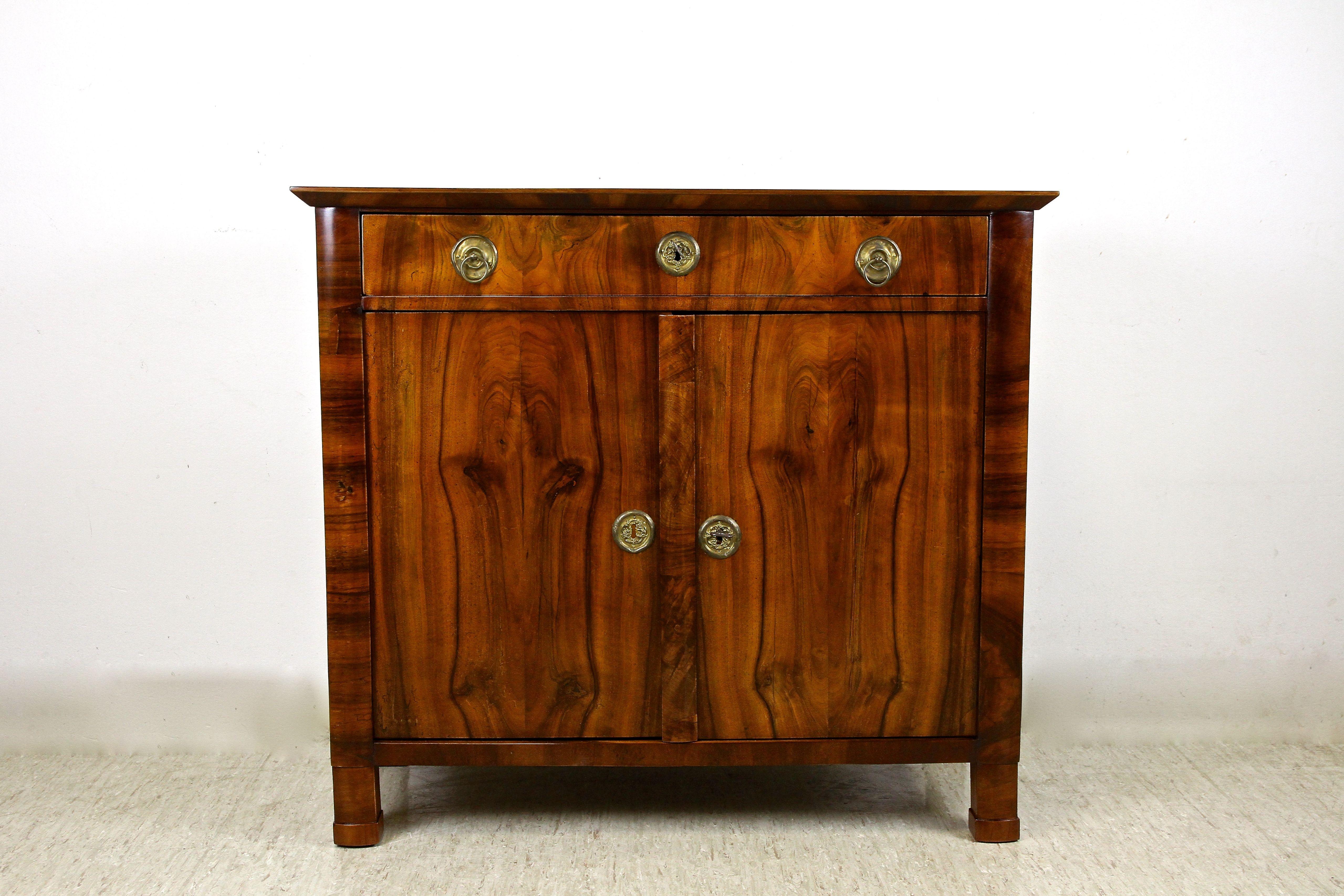 Marvellous 19th Century Nutwood Trumeau Commode from the famous Biedermeier period in Austria around 1830. Beautifully designed and constructed from spruce wood, this dresser shows a precious mirrormatched nutwood veneered surface, impressing with a