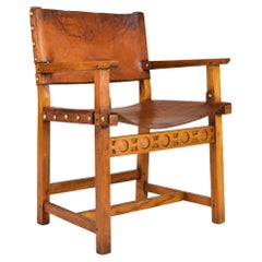 Fauteuil espagnol brutaliste Castellana du 19ème siècle en chêne et cuir cognac