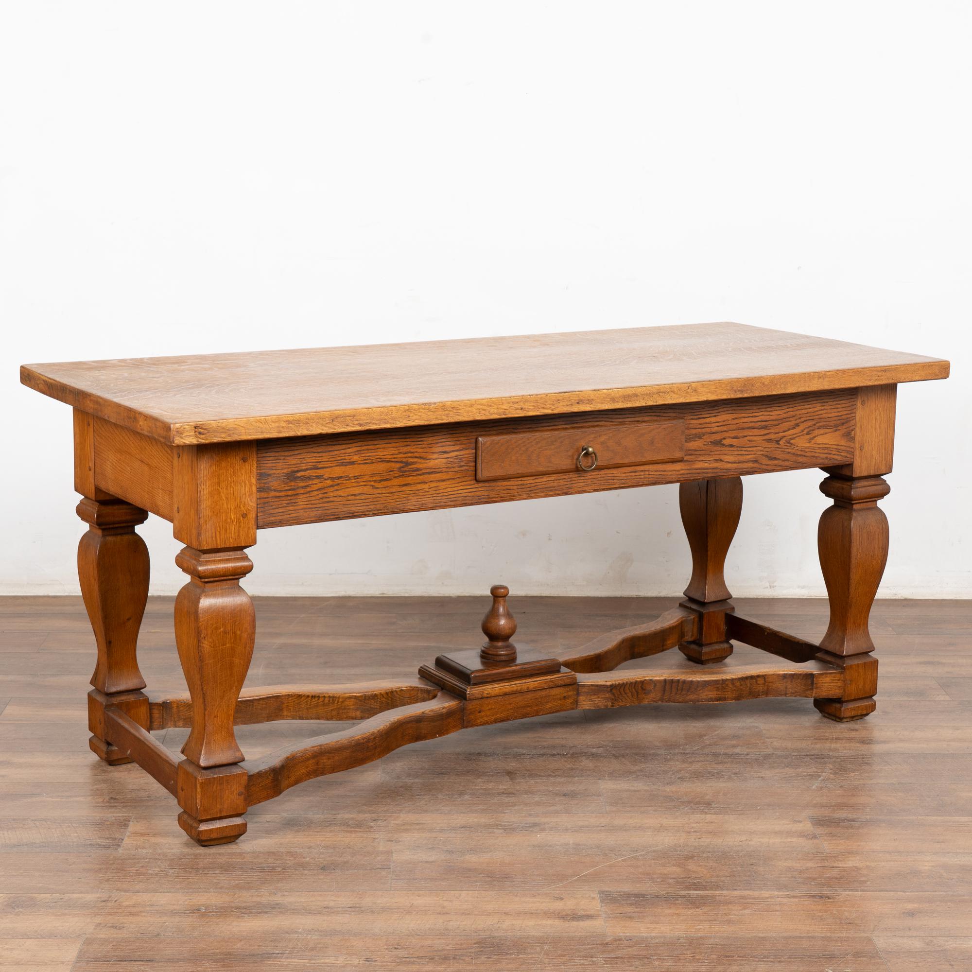 This handsome baroque oak library table with one drawer has heavily turned legs and an attractive X lower stretcher.
Note the rich patina of the top, with stains and scratches the result of over 150 years of use.
Restored, strong, stable and ready