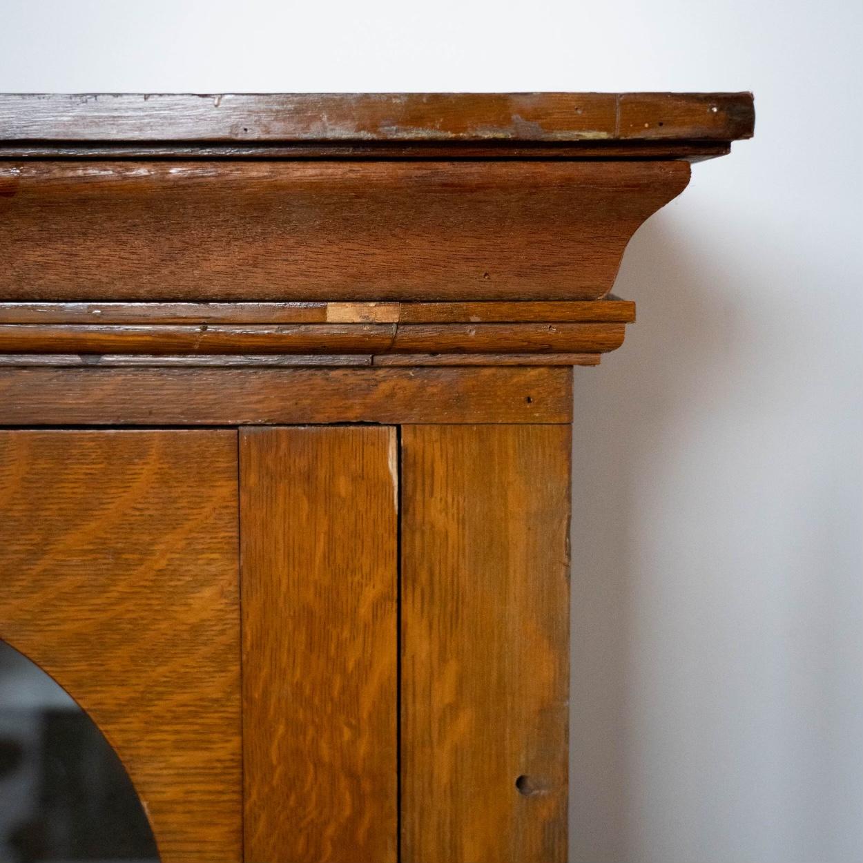 Beautiful heavy oak two piece cabinet with adjustable shelving, decorative panels and arched glass doors.

This is a well built cabinet originally from a boarding school in England.

Salvaged in 196- and brought to Canada. we have two identical.