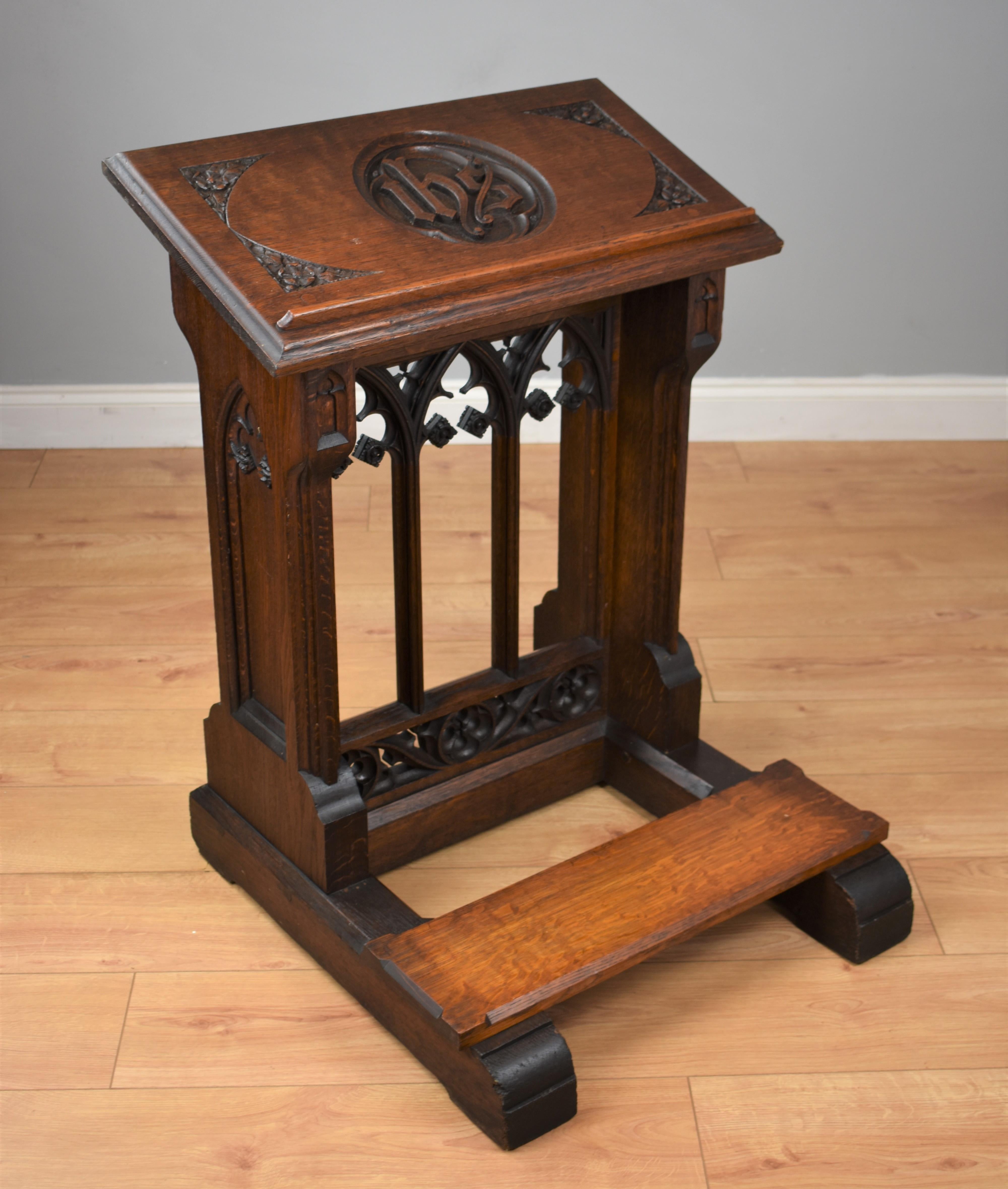 19th century oak church lectern-reading/praying stand in good condition having an inscription to the top ihs with a plaque under the bible
