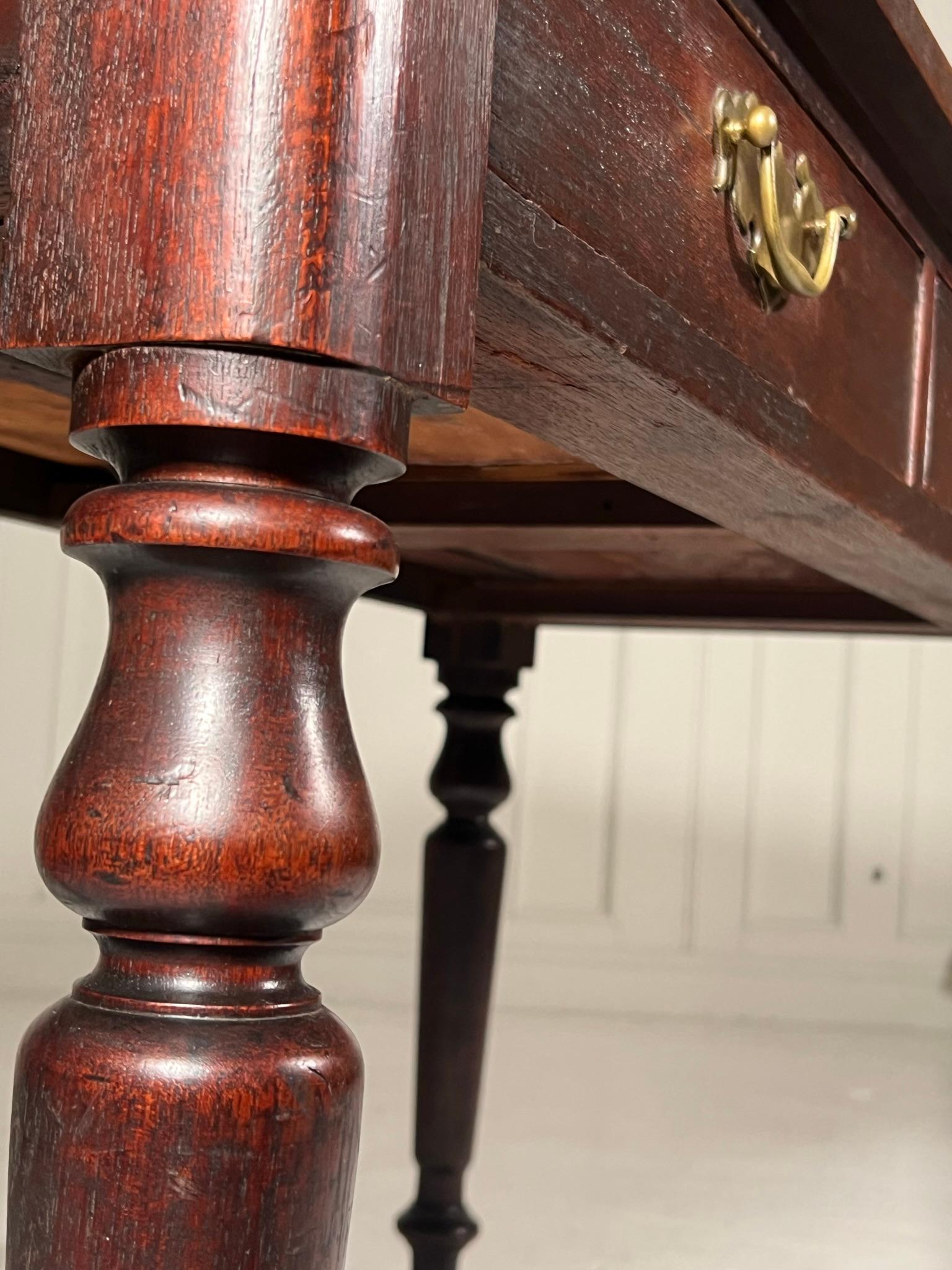 Sweet little English 19th century oak console table.

Standing on nicely turned legs with wonderful patination to the oak.

Some marks to the breadboard top as photographed all adding to the character of the piece.

Height 71cm
Width 103cm
Depth