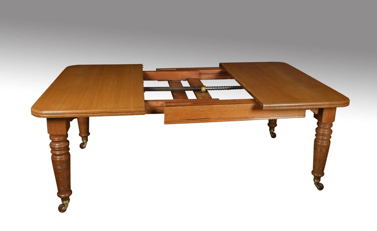 19th century oak dining table, the rectangular top with rounded corners and moulded edge, the telescopic action opening to incorporate three leaves, on turned tapering legs with ceramic casters (will seat 10-12 people)
Dimensions:
Height 28.5