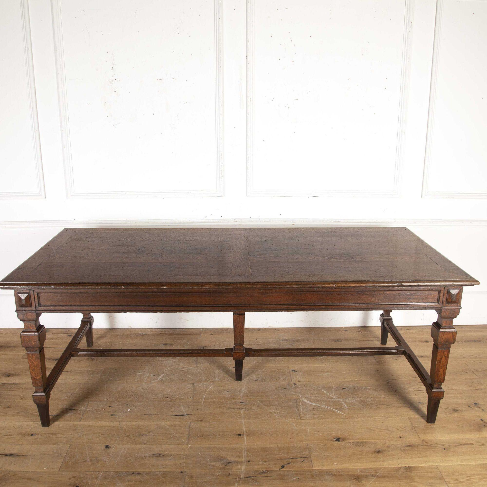Large English oak dining table dating to the mid 19th century.
This wonderful table is of good country house form and condition.
The top features an unusual design with inset panels and very attractive colouring. 
The frieze is panelled in the