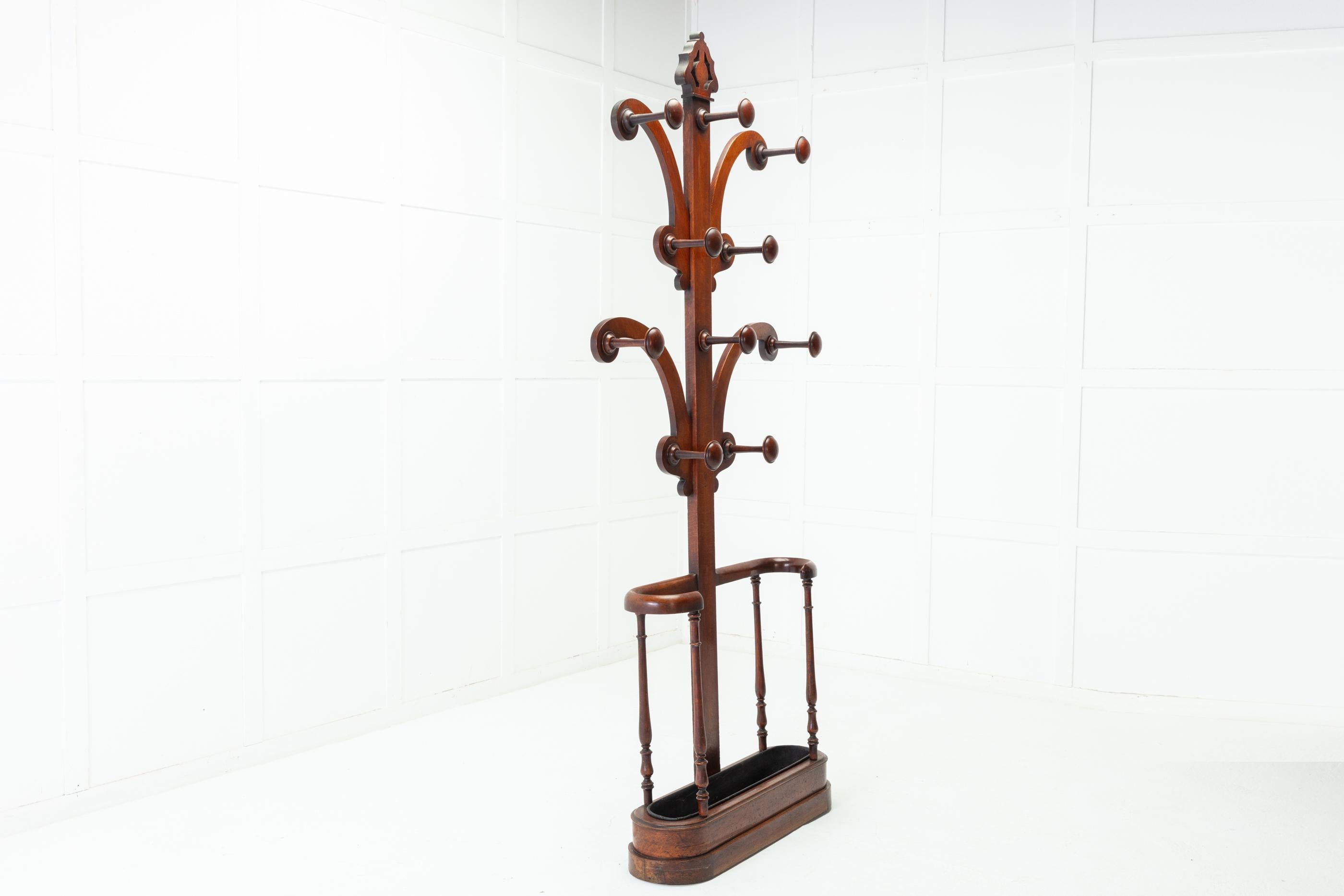 Splendid, large 19th century oak hat, coat and umbrella stand or ‘hall tree’, circa 1860.

The top is a decoratively carved finial and below are ten large, turned mushroom shaped hat or coat hooks arranged over four shaped branches. Below is the
