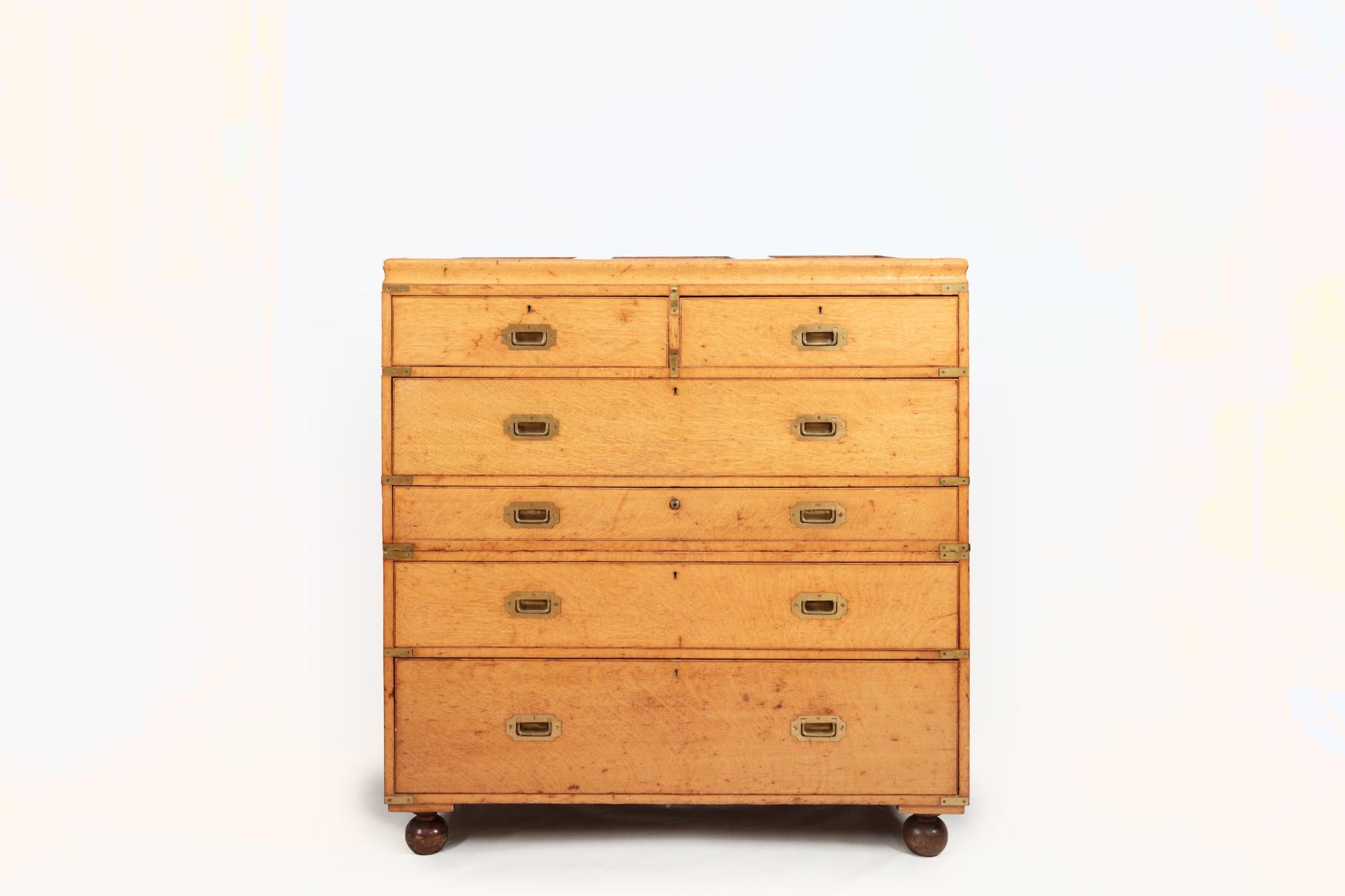 19th Century large oak military chest. The top lifting to reveal four shelves and centred by a mirror over two top short drawers and four long drawers with brass pulls. The centre drawer opening to reveal a writing scribe and writing box terminating