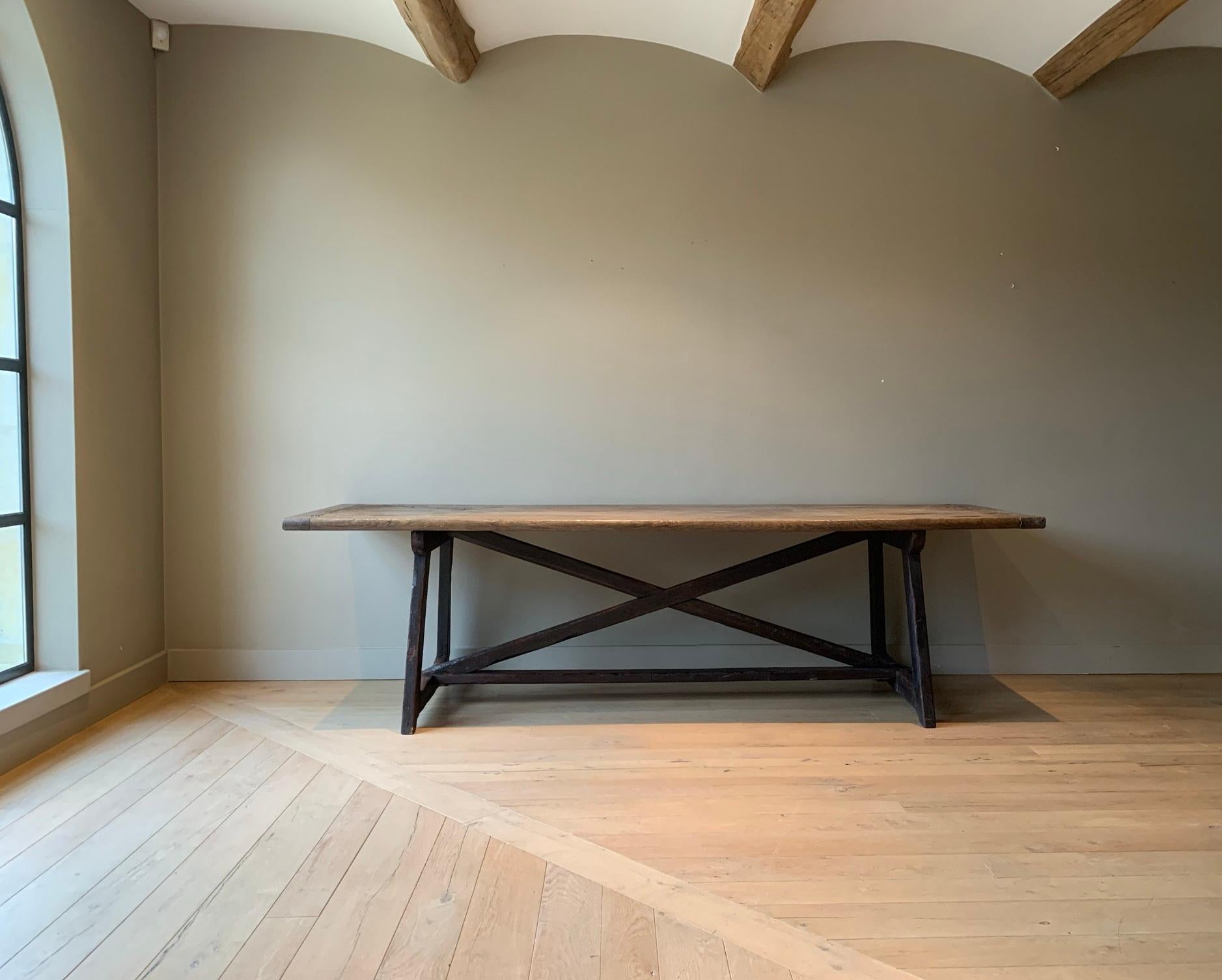 A rare and beautifully proportioned large trestle table from the Pyrinees. Refectory tables like these were made for centuries by rural craftsmen. This particular exemple was completely made by hand and two huge oak boards from the same tree were