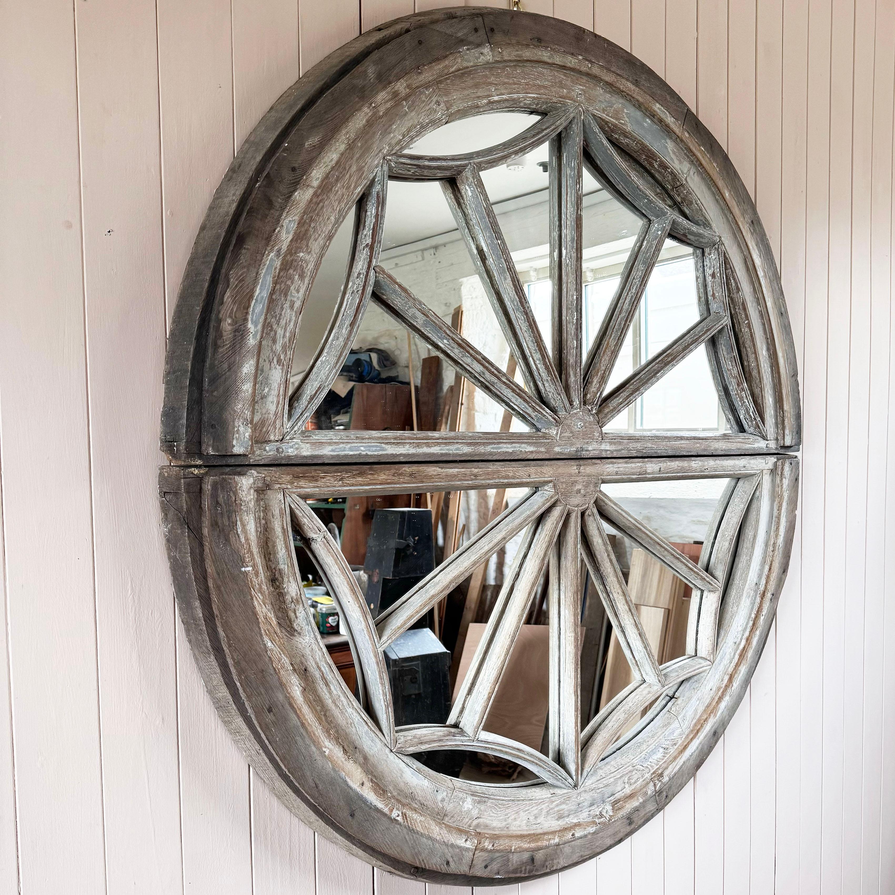 This oak window frame is early 19th century from France.  Originally painted and still retaining some of the paint with a wonderful naturally bleached look.

We have replaced the glass with mirror producing this large scale interesting