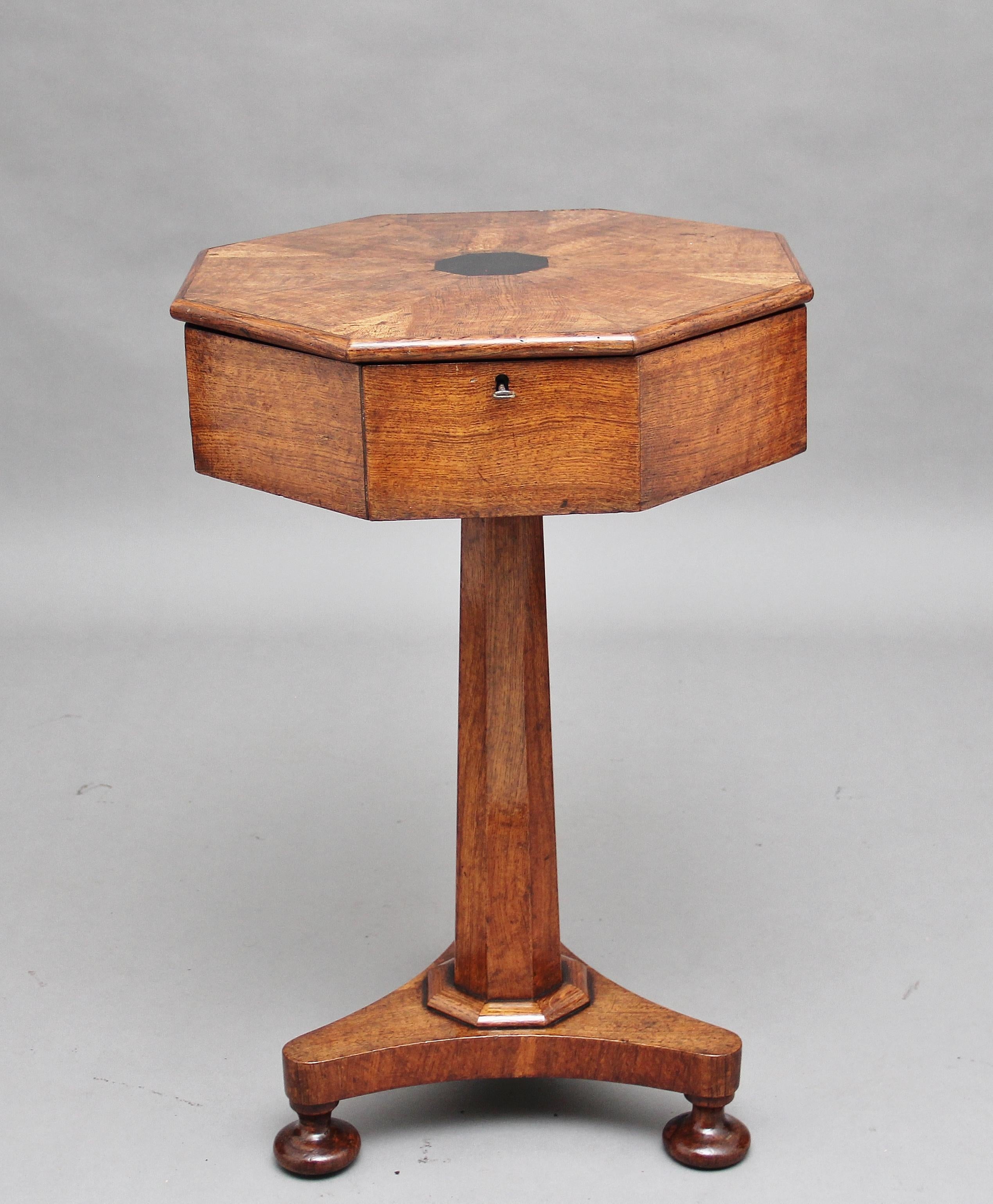 A lovely quality mid-19th century work table, the segmented octagonal shaped top having ebony inlay at the centre opening to reveal an assortment of various compartments, some with lift up lids, supported on a tapering octagonal shaped column