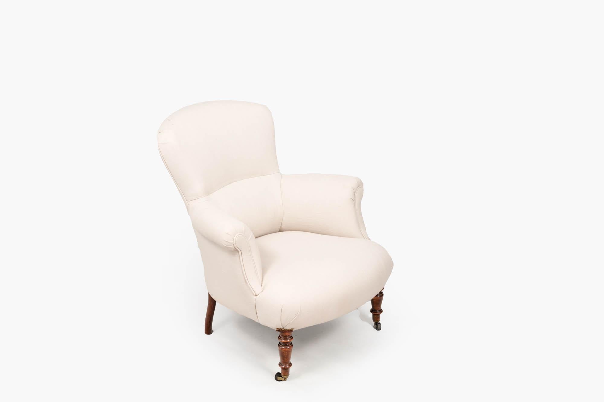 19th Century occasional chair in the French style, with simply turned mahogany legs to the front terminating on brass castors, and two plain mahogany legs to the rear. This piece has recently been re-upholstered in a simple fabric with decorative