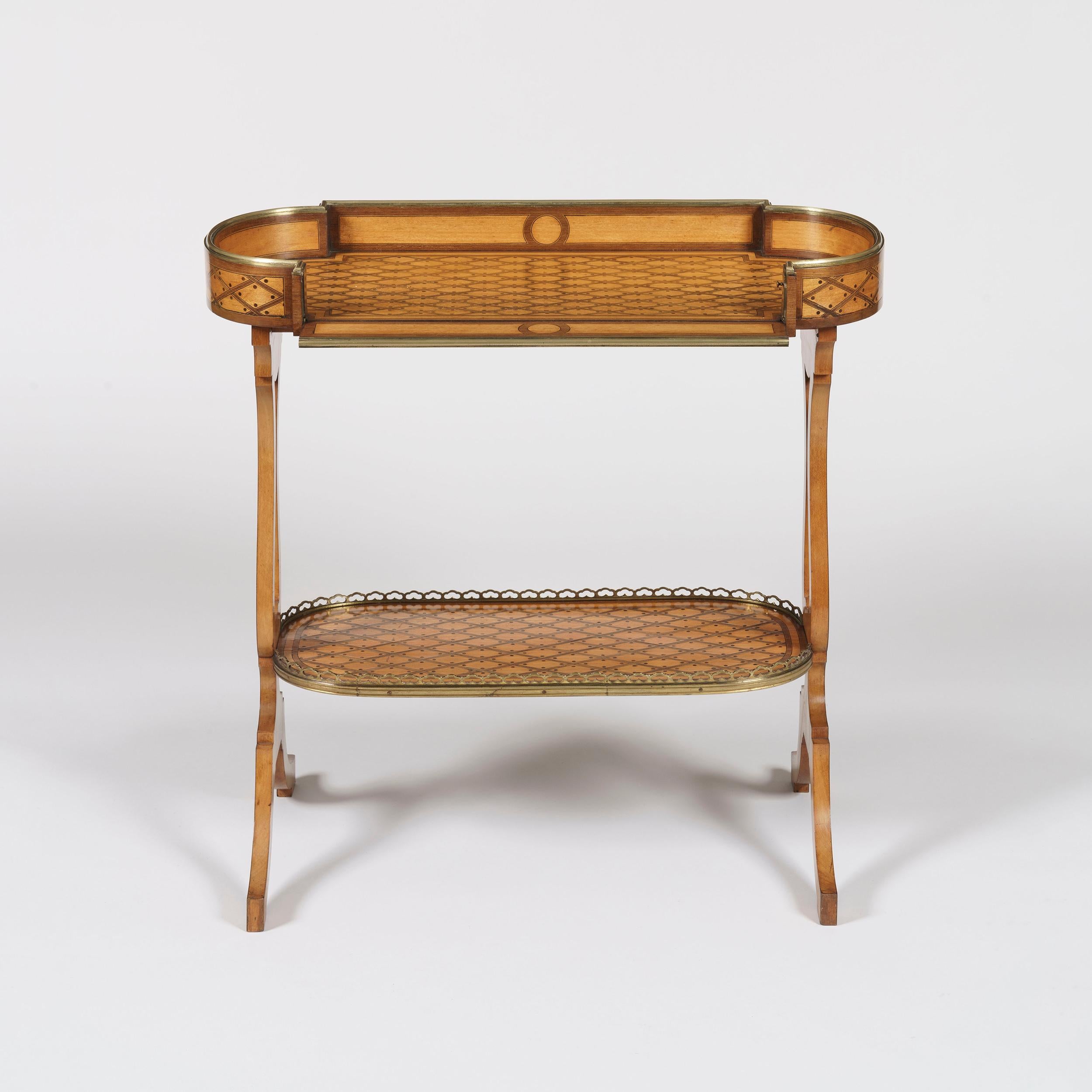 A 'Vide-Poche' table
Firmly attributed to Donald Ross of London

Constructed in satinwood with kingwood highlights and an all-over trellis design; the shaped and pierced end support table has bifurcated legs with an elliptical lower tier dressed